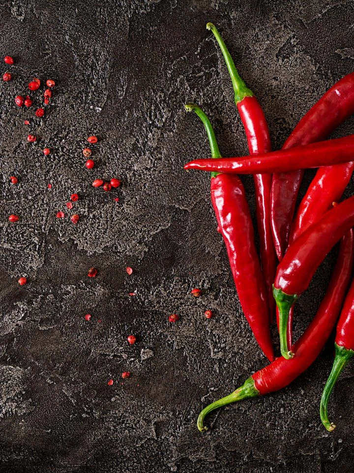 Red hot cayenne chili peppers on grey table