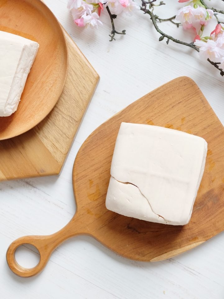 White raw tofu on wooden board