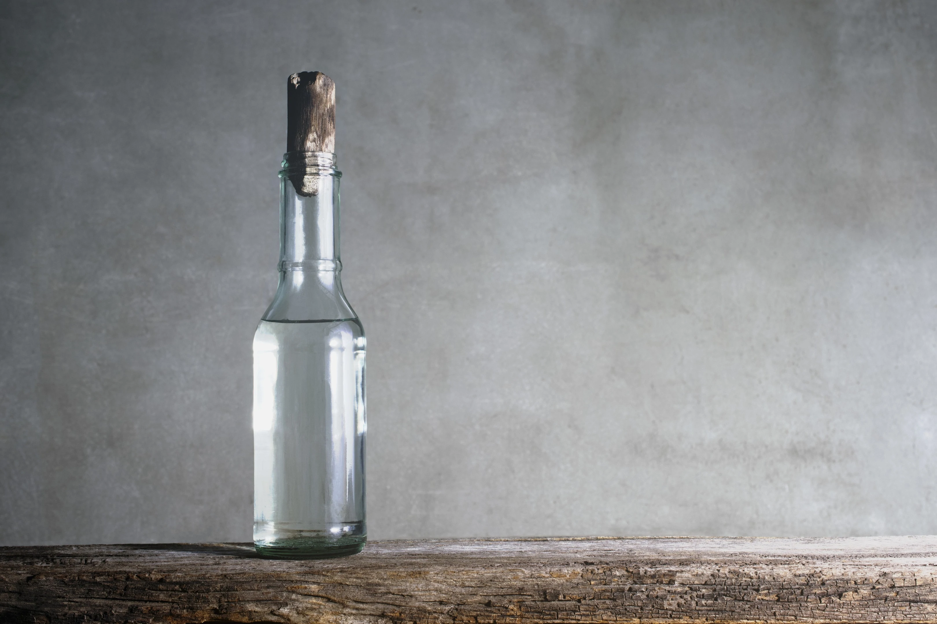 White vinegar bottle on wood table