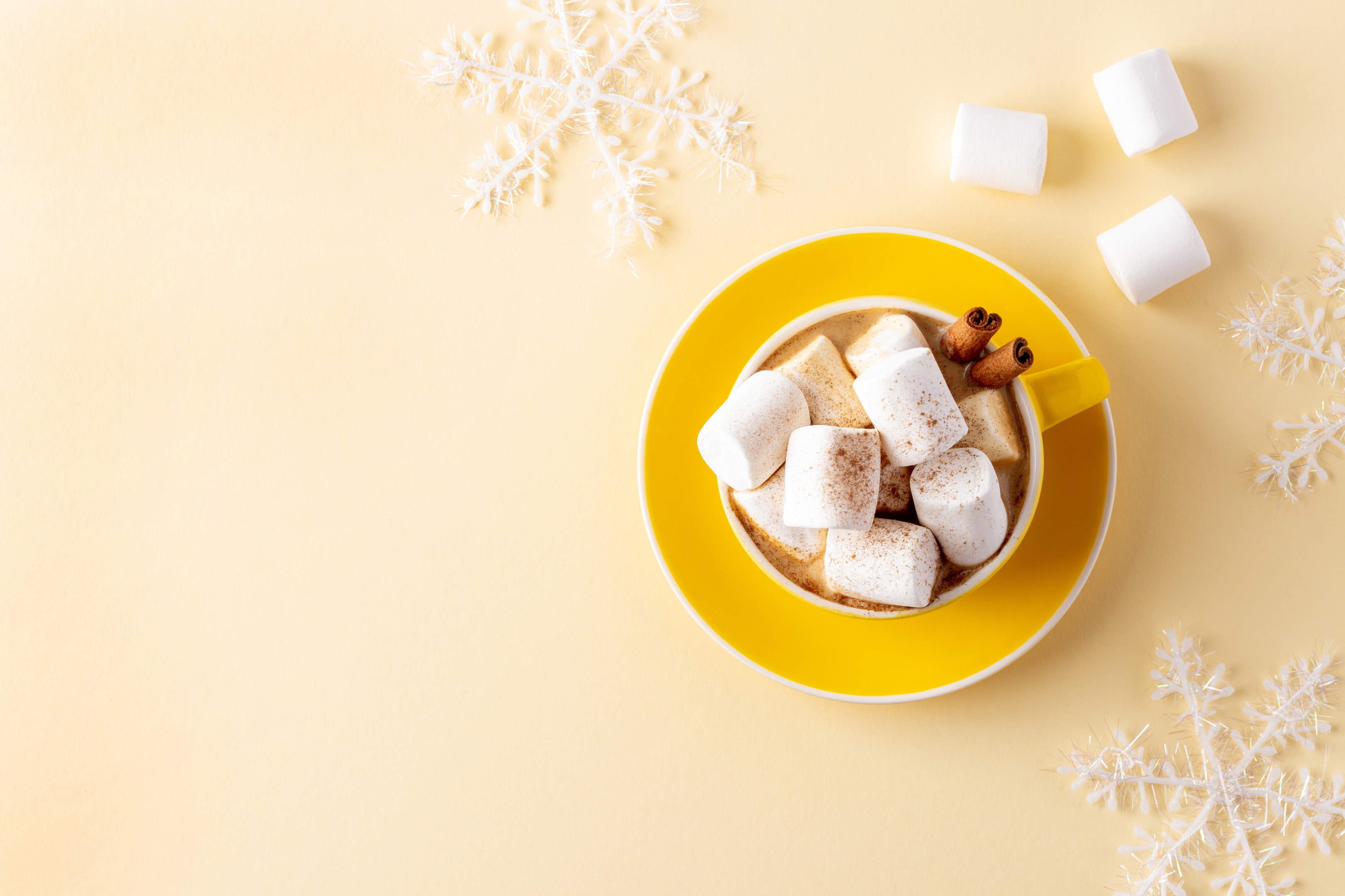 Yellow mug hot chocolate with marshmallows
