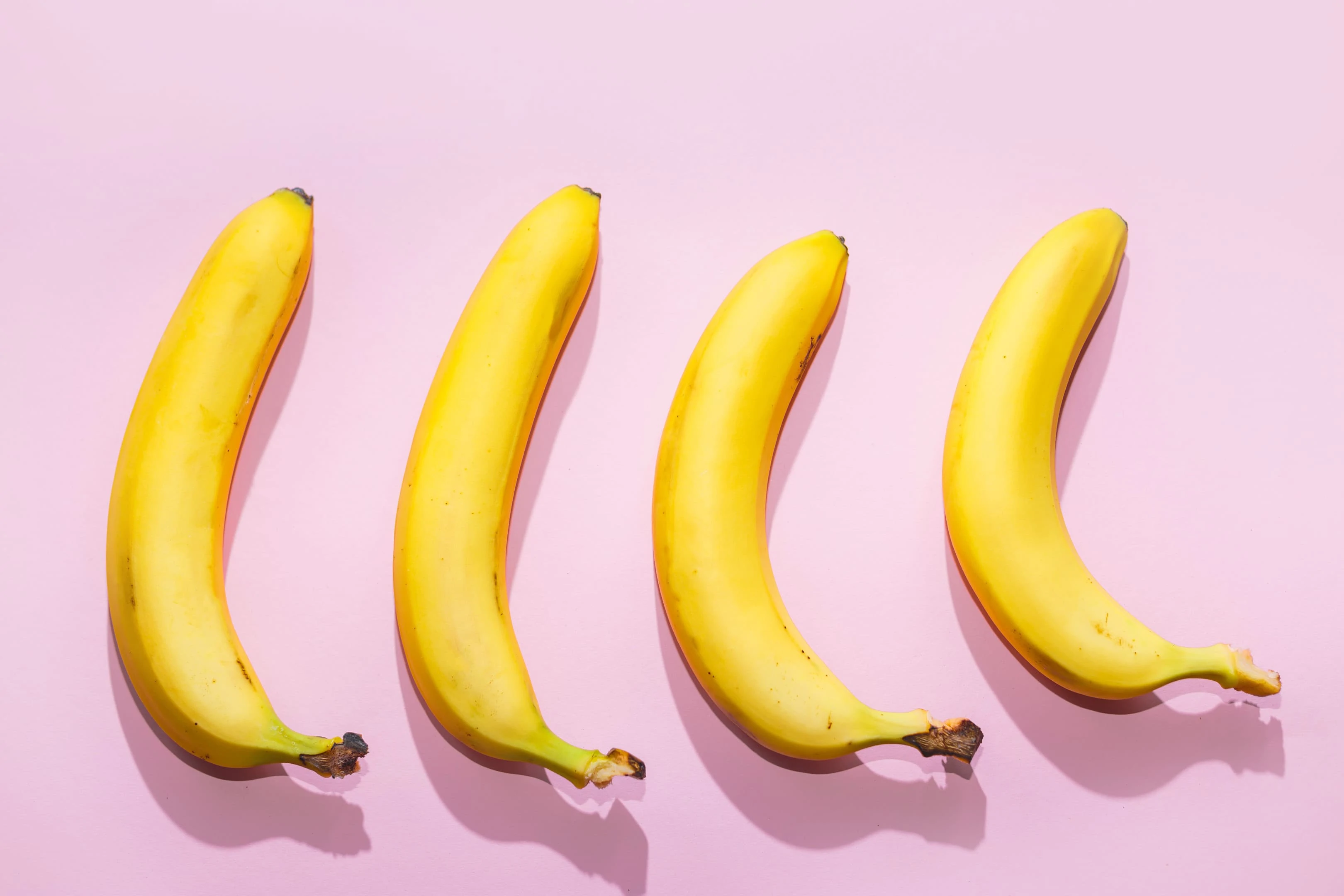 Bananas on pink pastel background