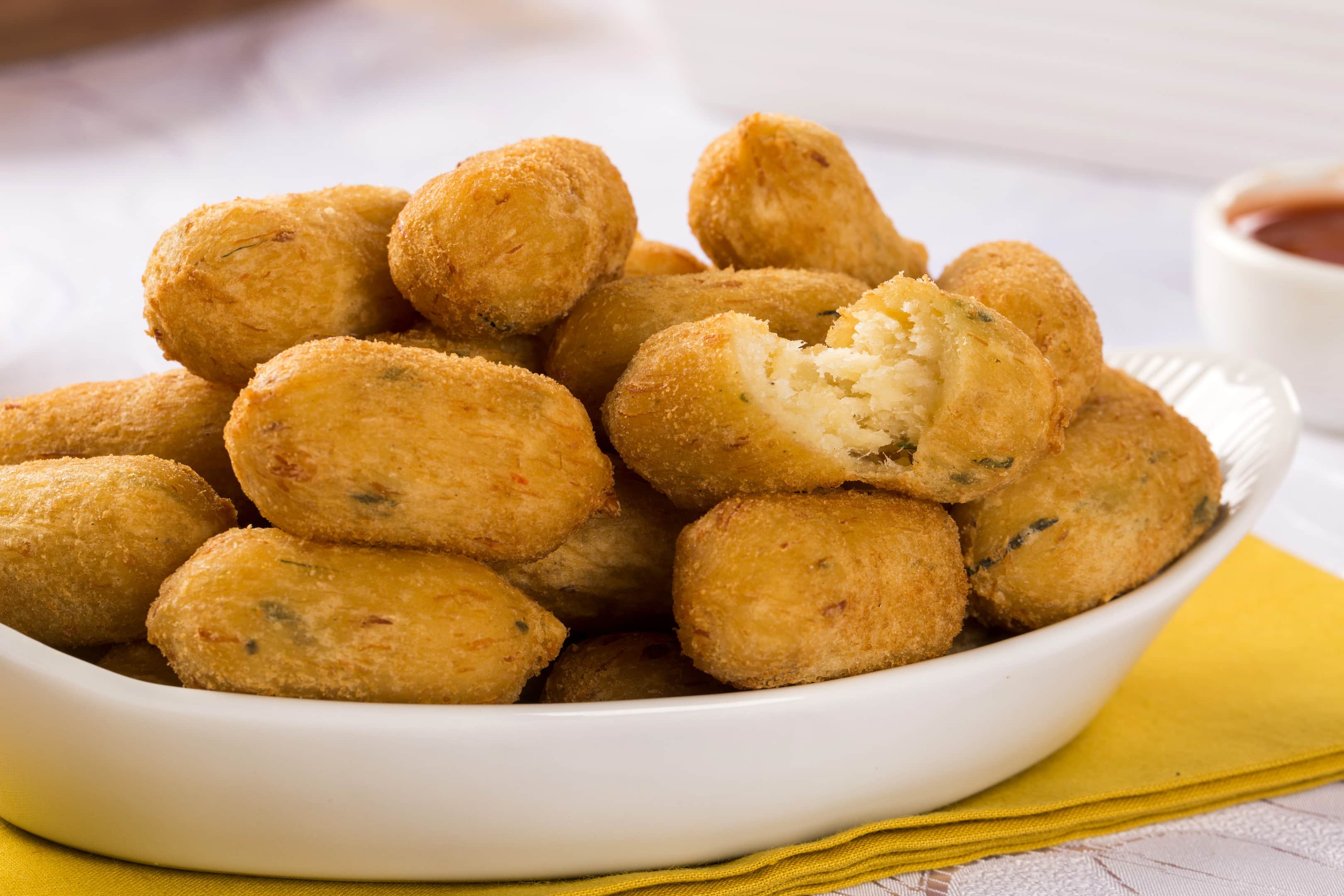 Caribbean conch fritters in white plate