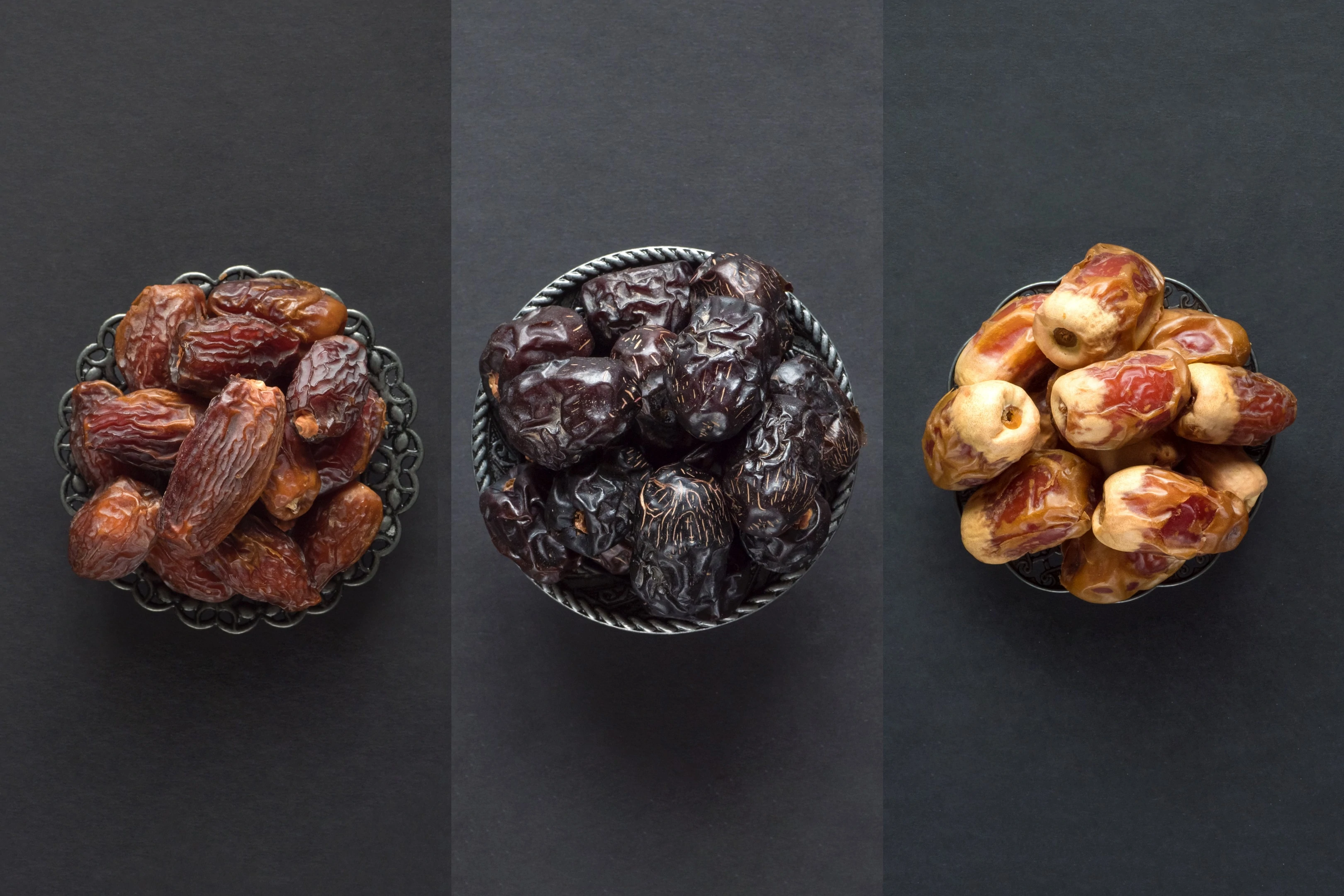 Dates fruits in bowls on dark table