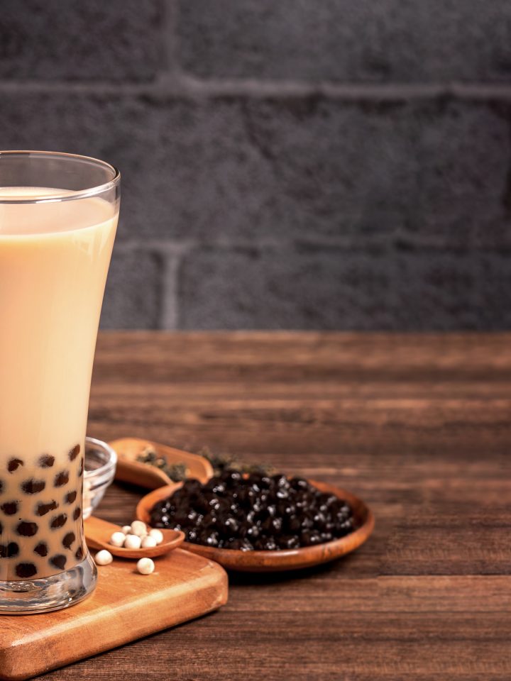Delicious bubble milk tea with tapioca pearl ball glass on wooden table