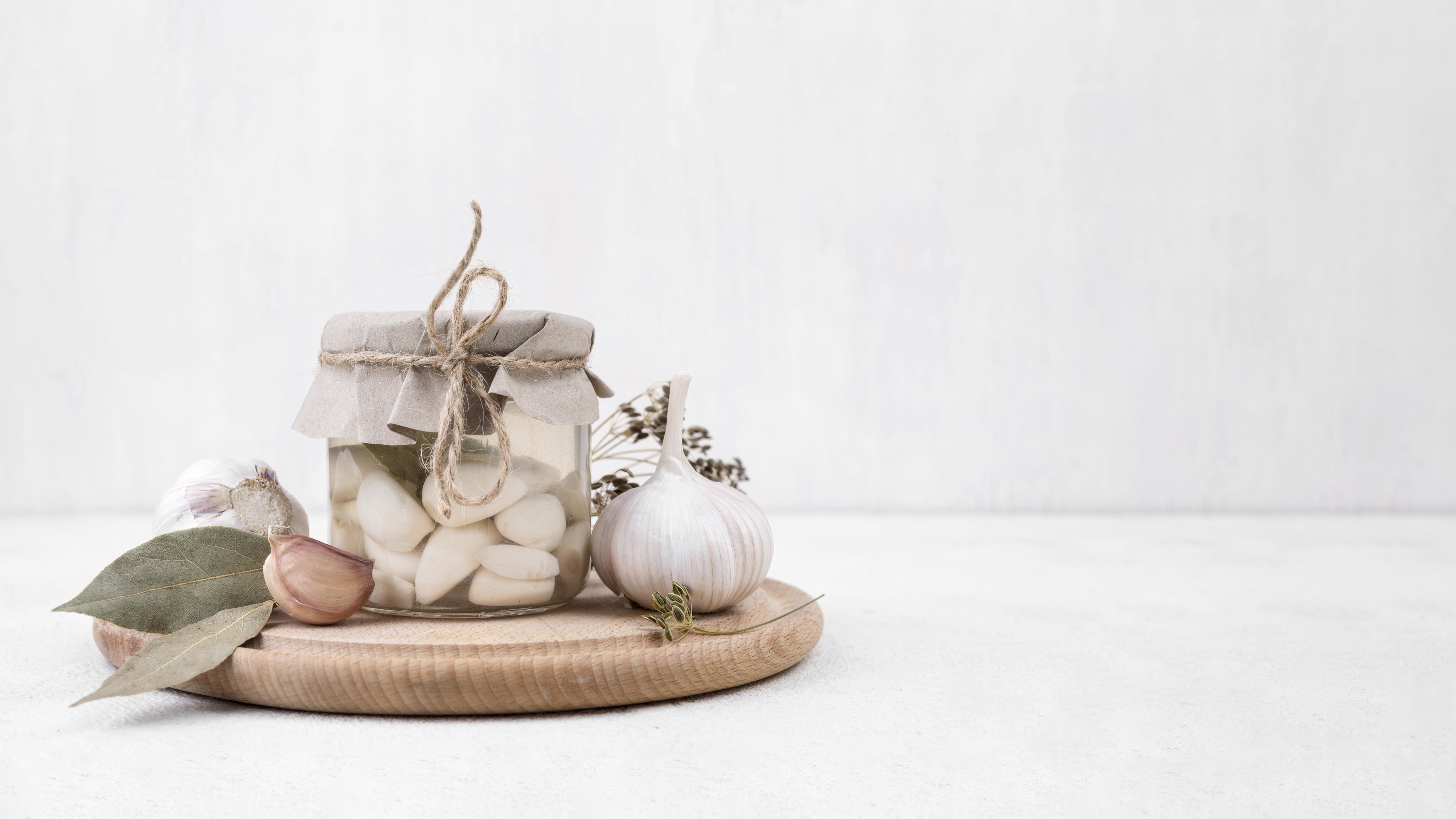 Garlic cloves with jar of peeled garlic