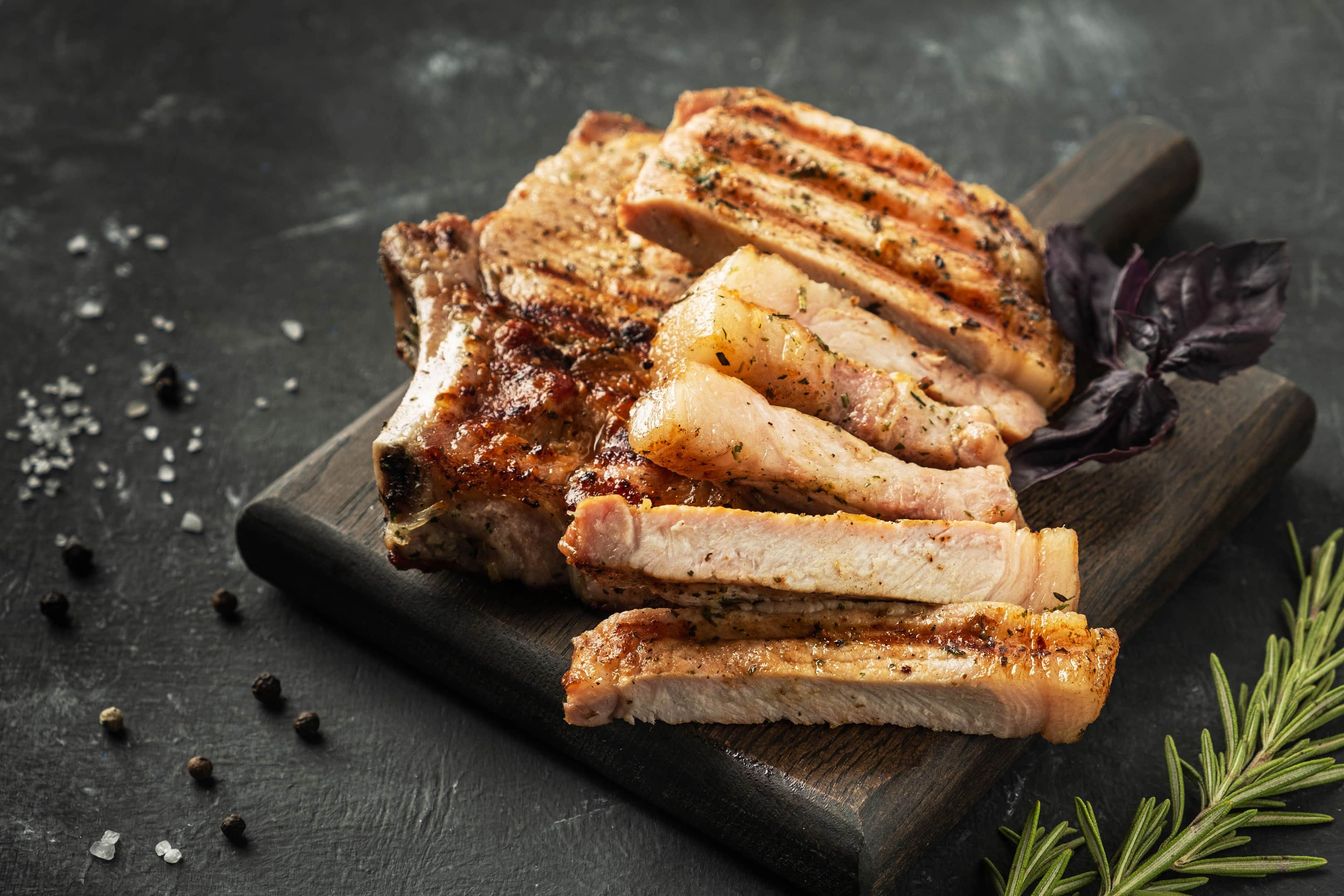 Grilled and sliced pork chops which are foods without folic acid