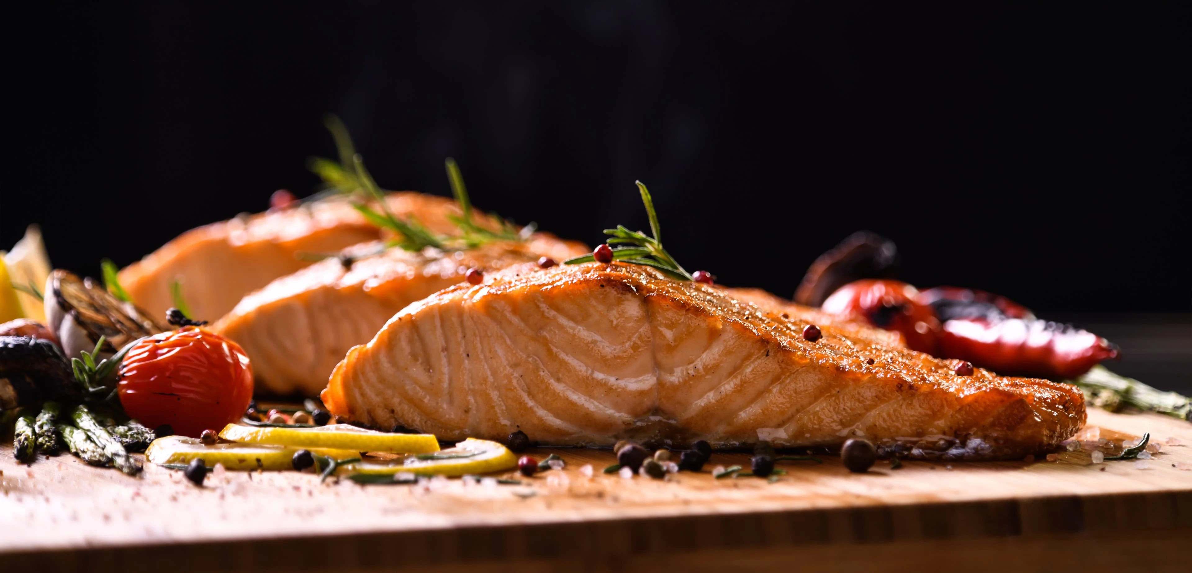 Grilled salmon fish on wooden table
