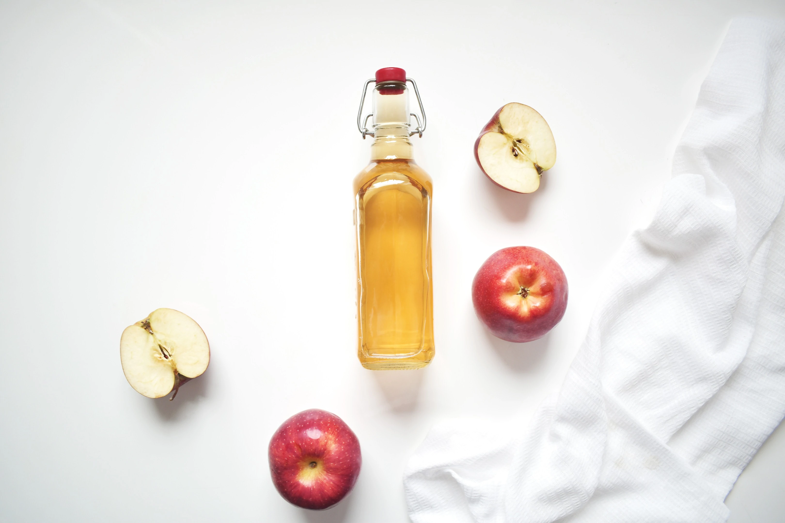 Natural apple cider vinegar on white background