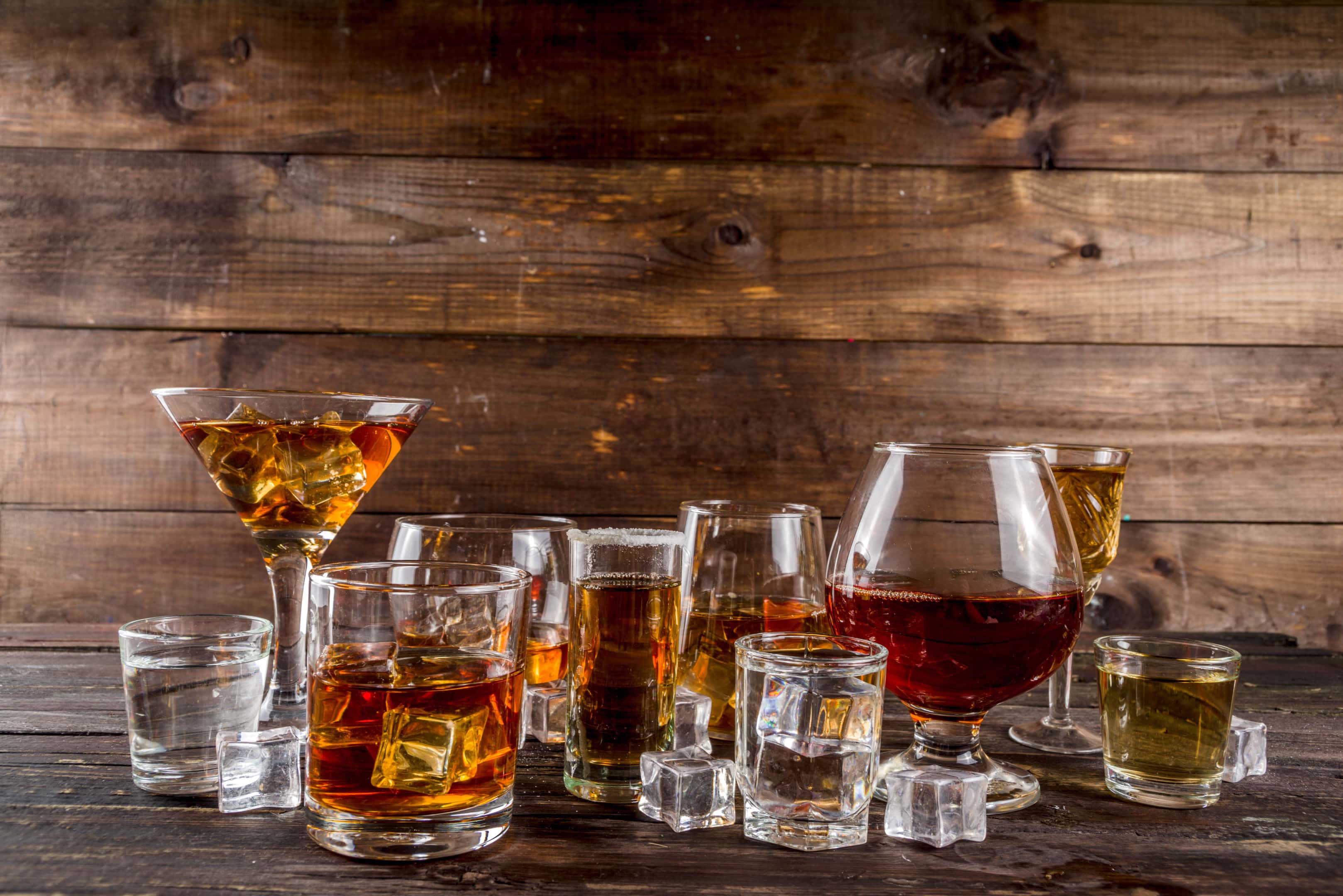 Selection of alcoholic drinks on wooden background