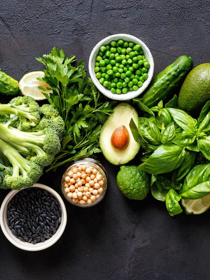Various leafy green vegetables on dark background