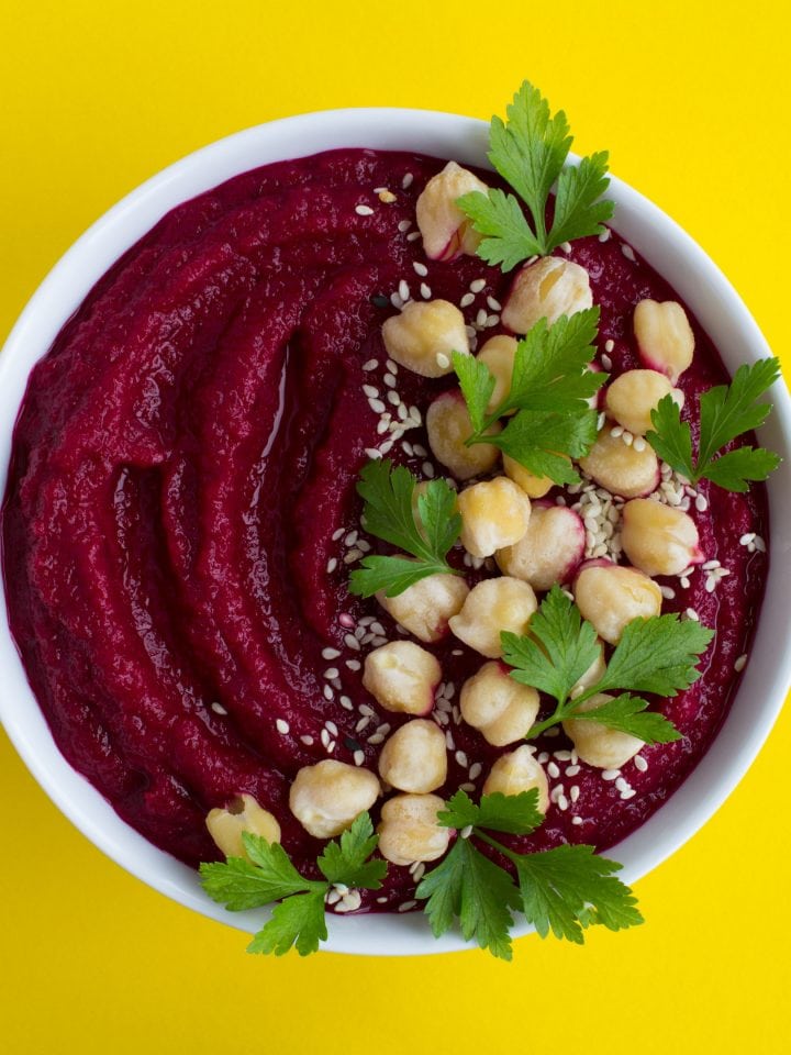 Vegan smoothie bowl with beetroot chickpea on yellow background