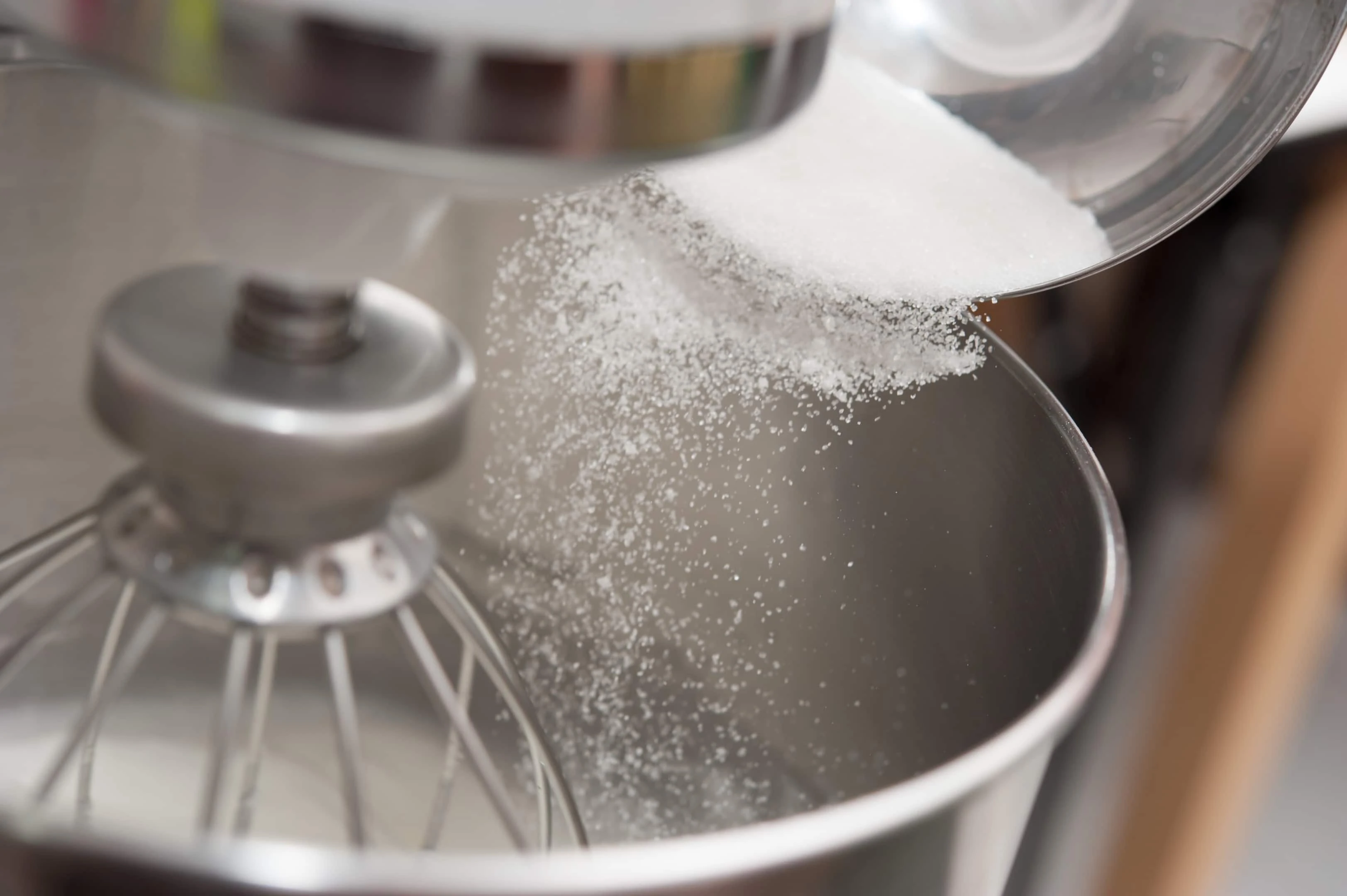 Adding sugar into mixing machine bowl