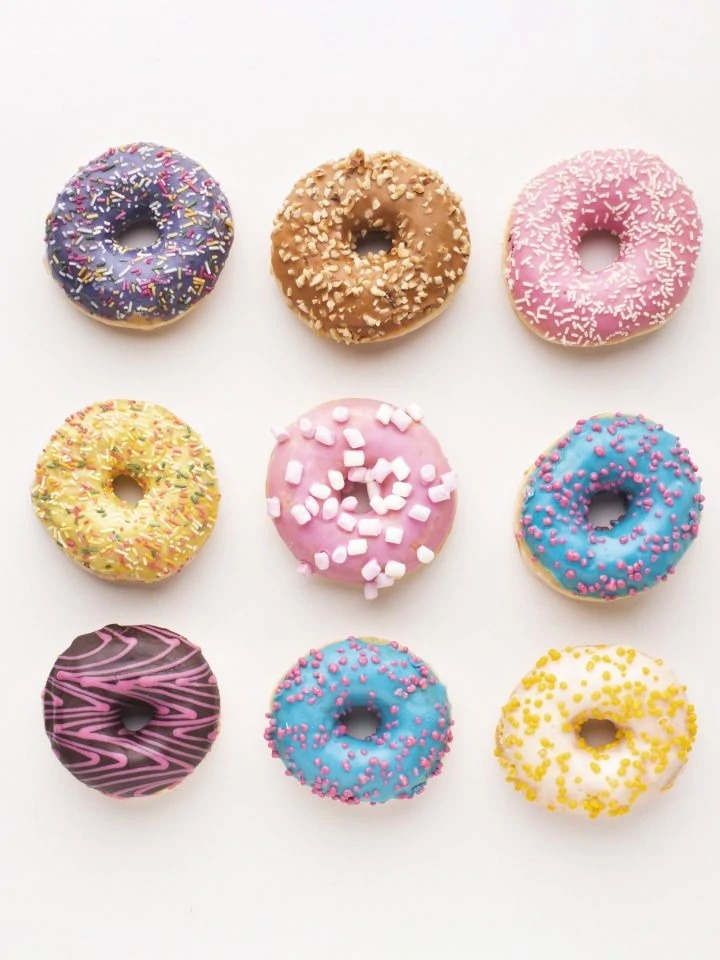 Assorted delicious donuts on white background