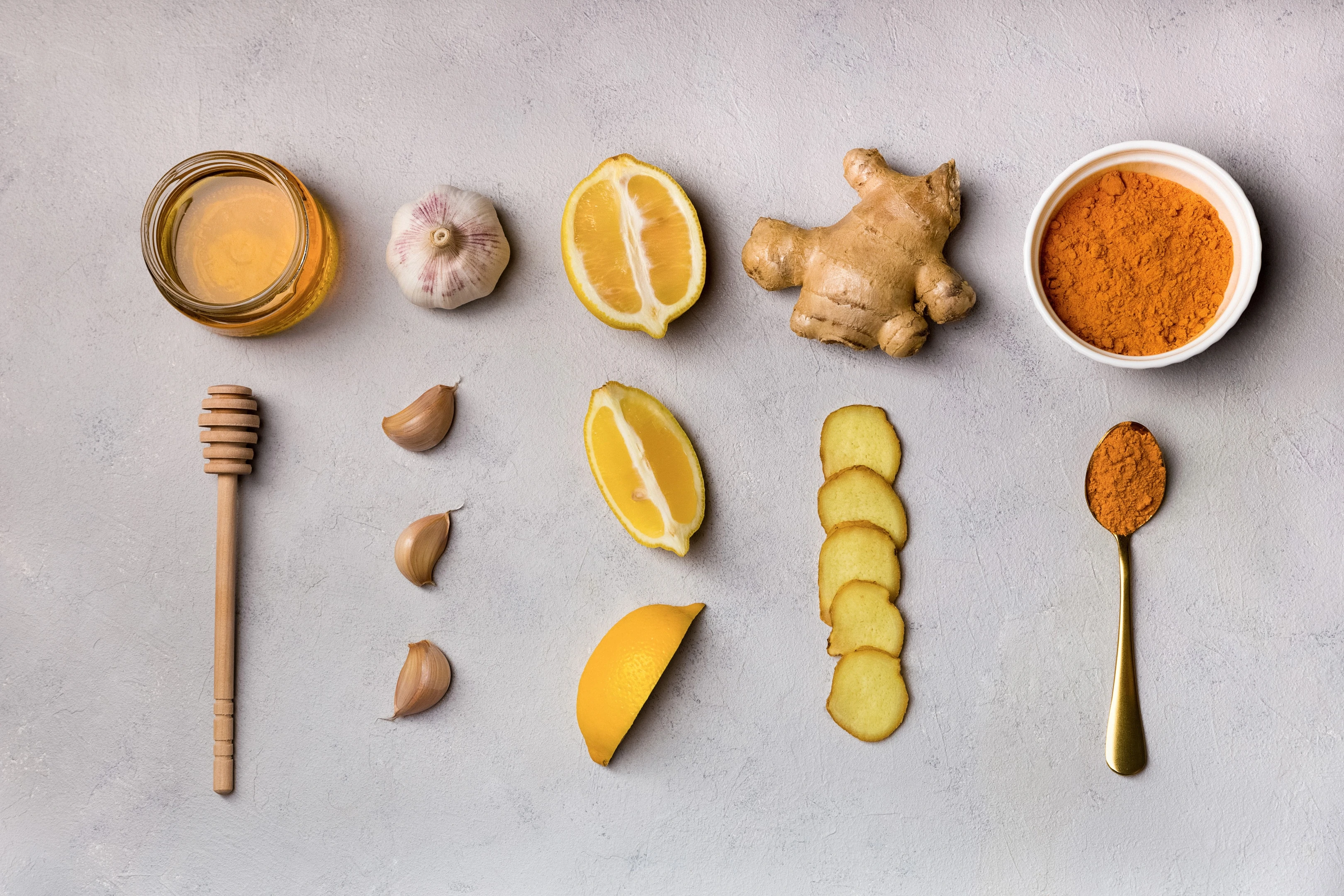 Ginger, garlic, turmeric, honey and lemon on table