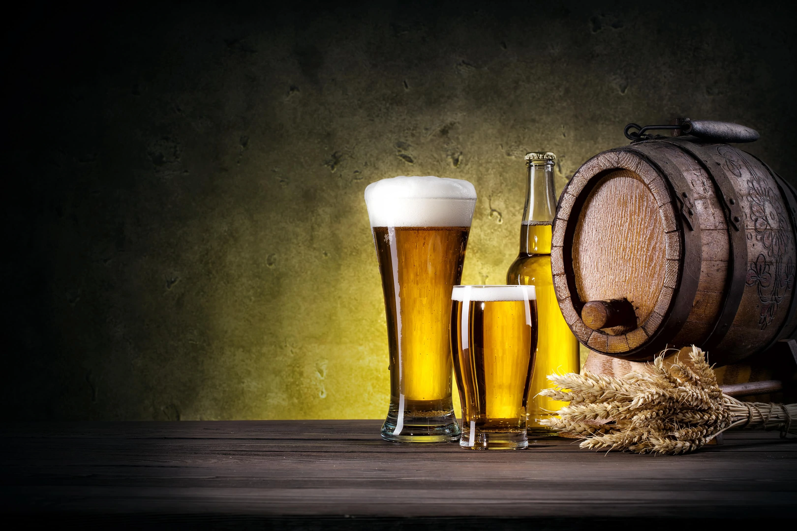 Glasses of beer with beer barrel