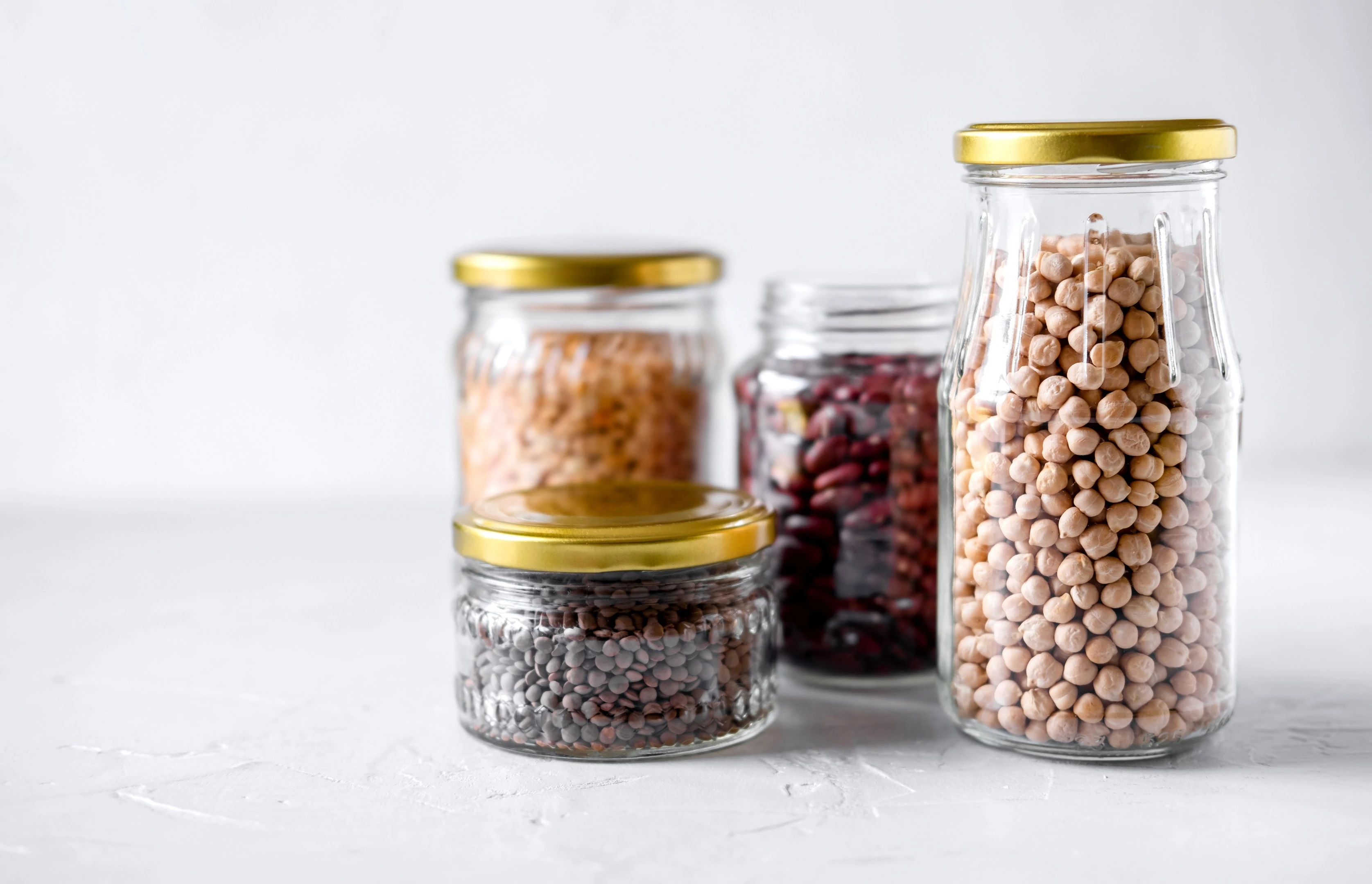 Legumes chickpeas and lentils in glass jars