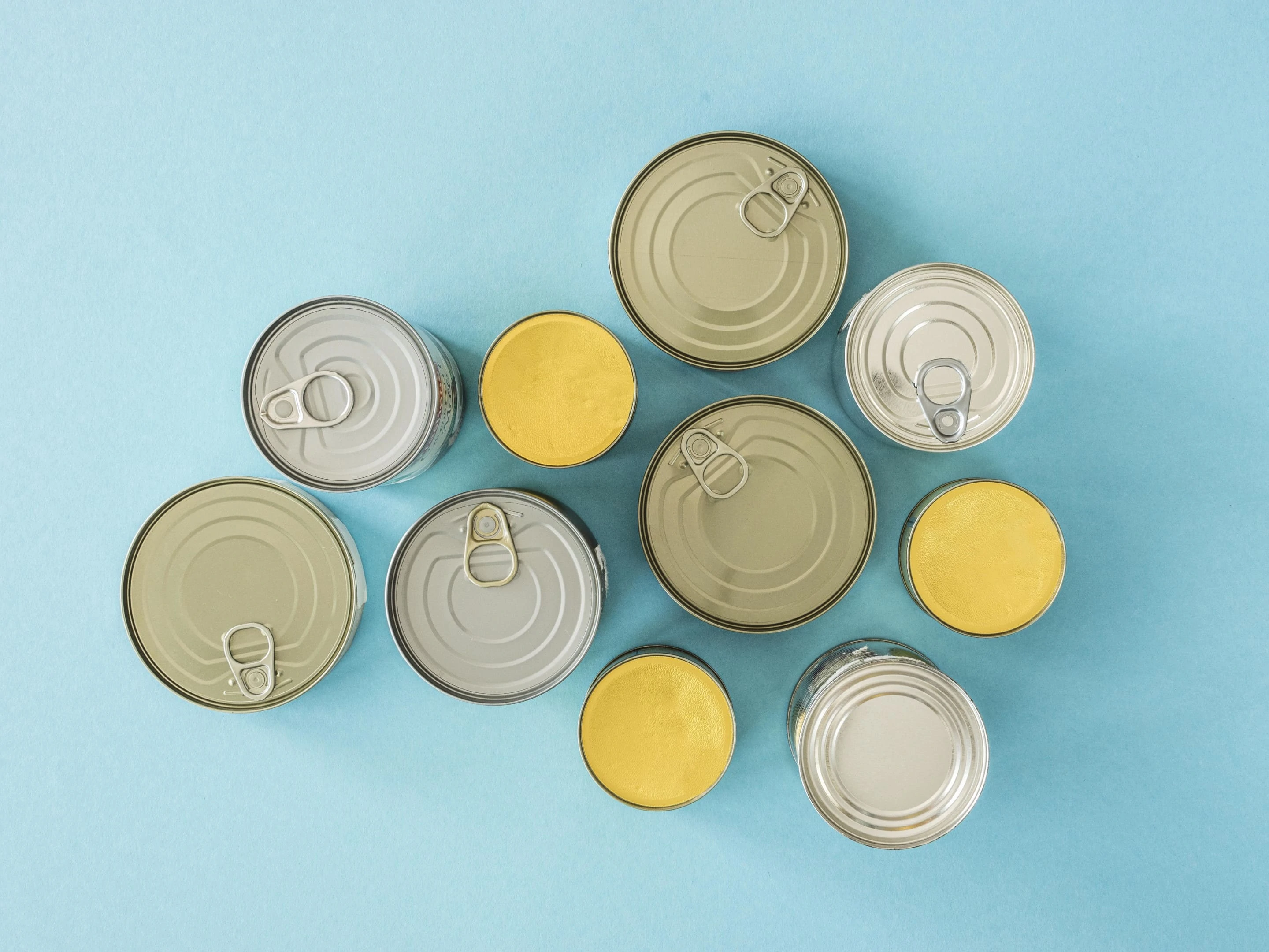 Top view of canned food on blue background