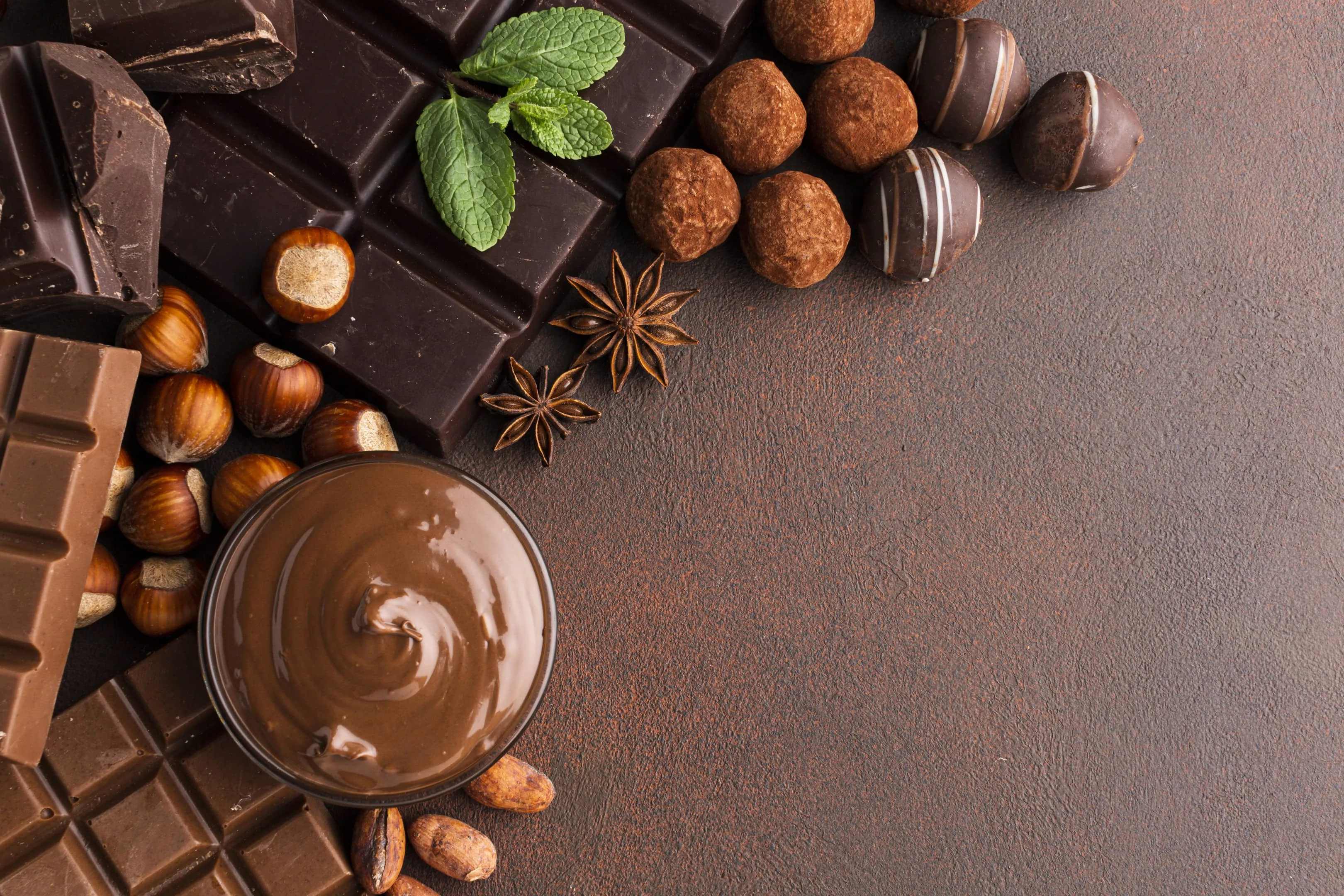 Variety of chocolate on brown surface