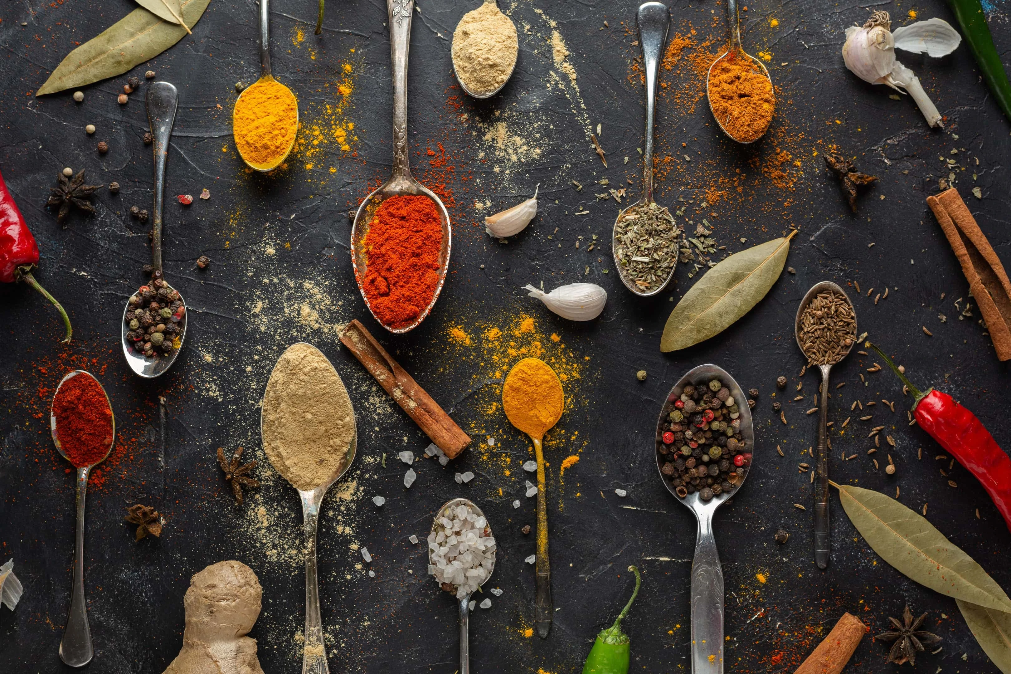 Variety of spices on black table