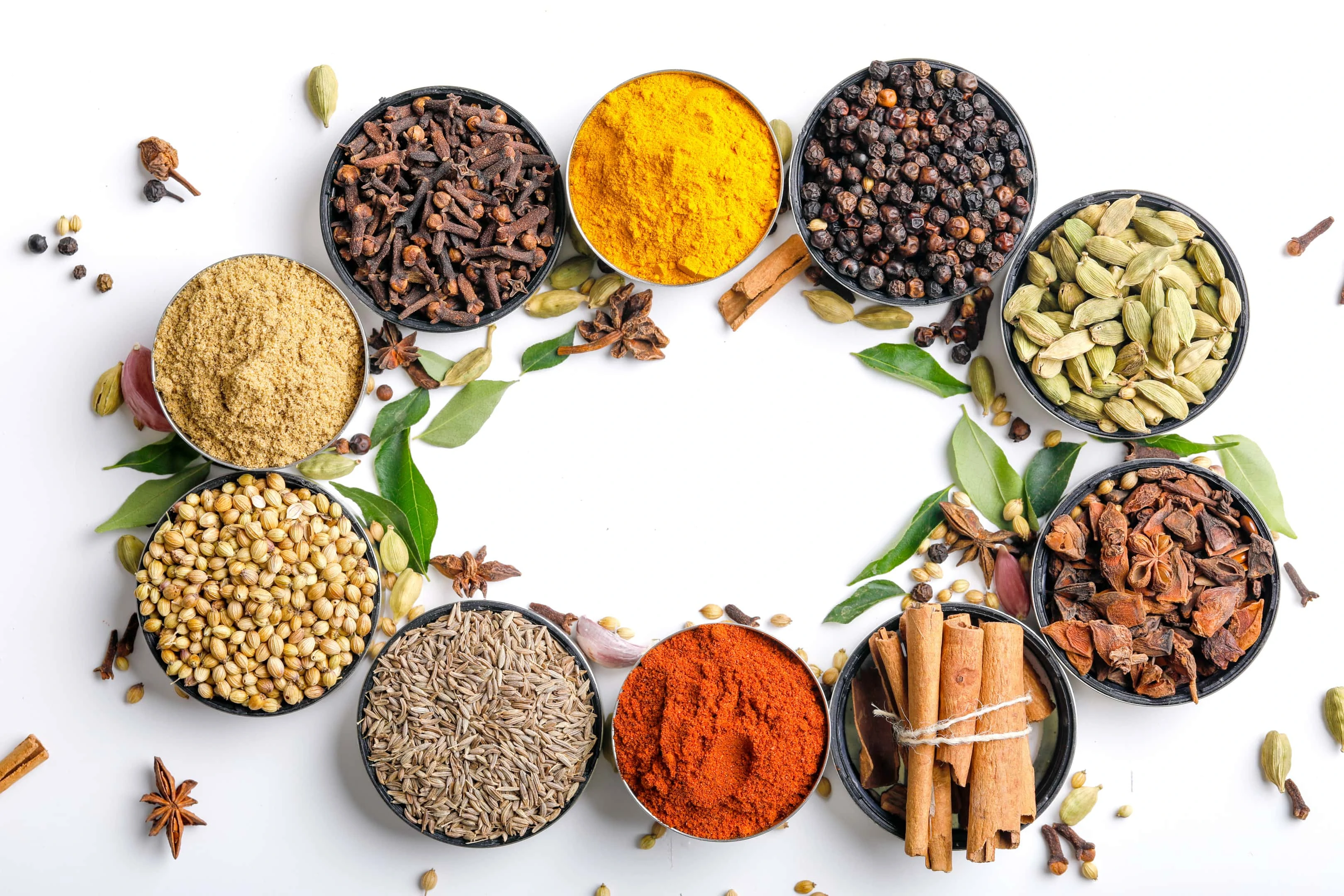 Various spices in bowls on white background