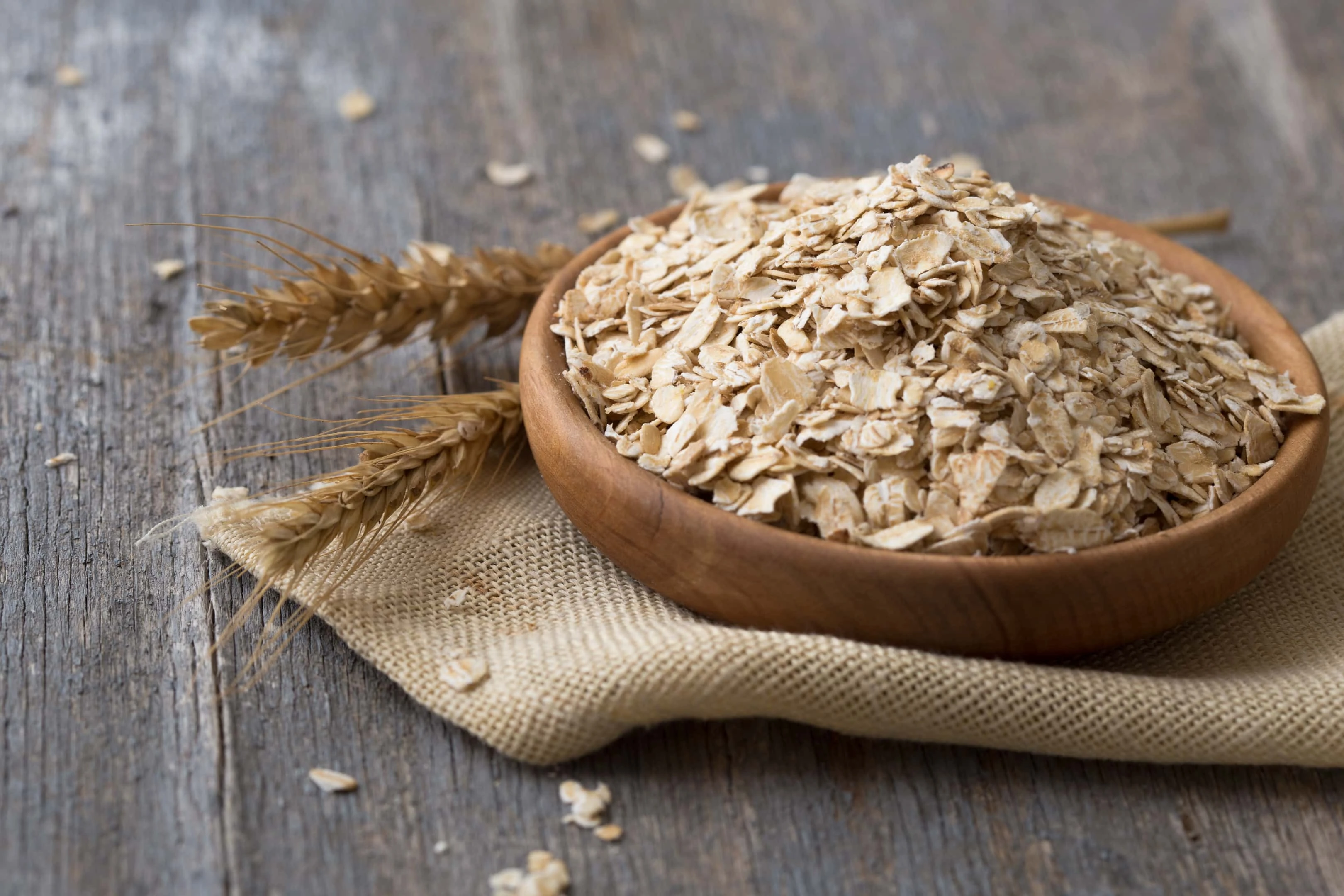 Oat flakes in wooden bowl