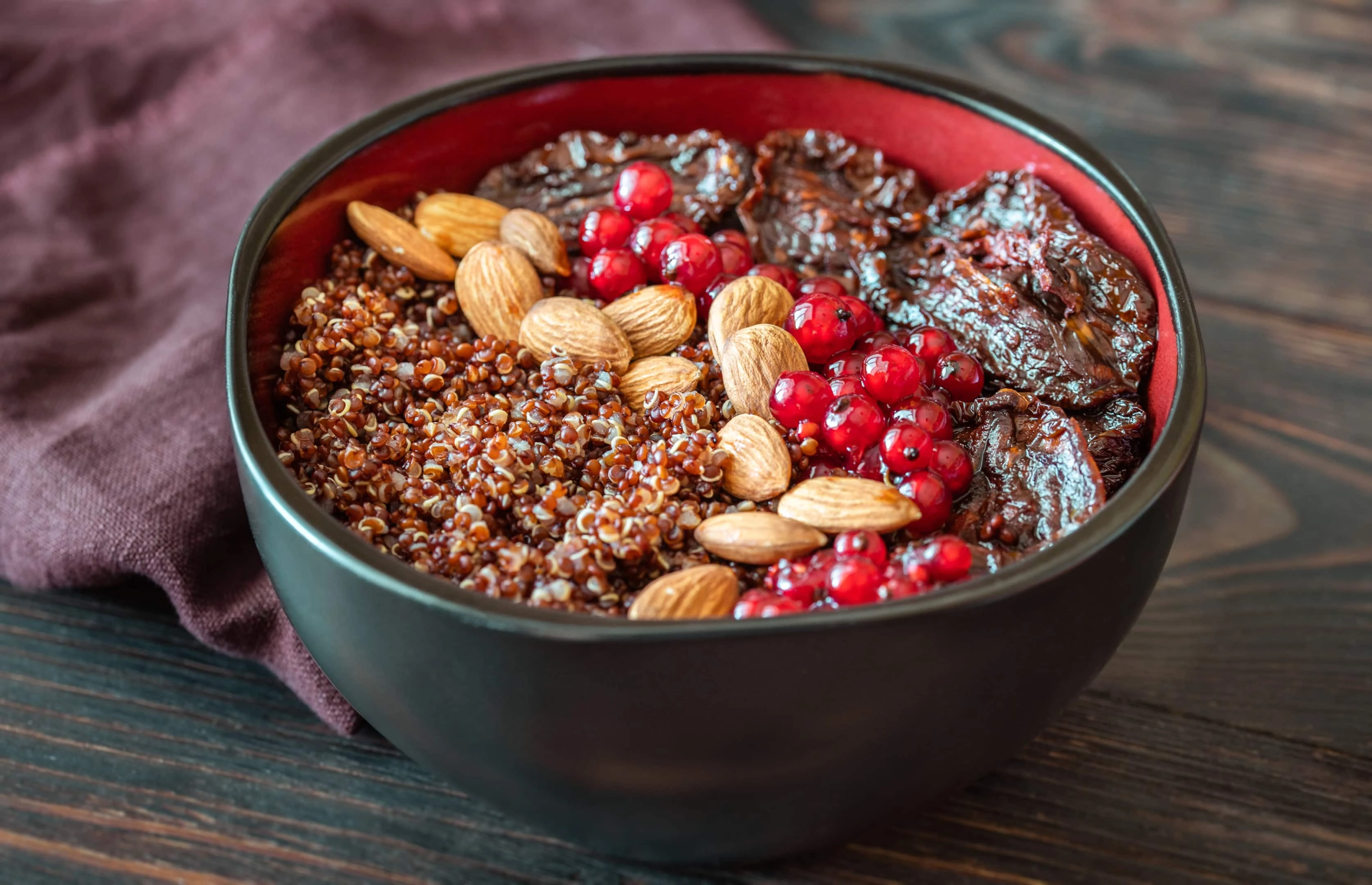 Bowl With Red Quinoa Olives Sun Dried Tomatoes Berries and Almonds