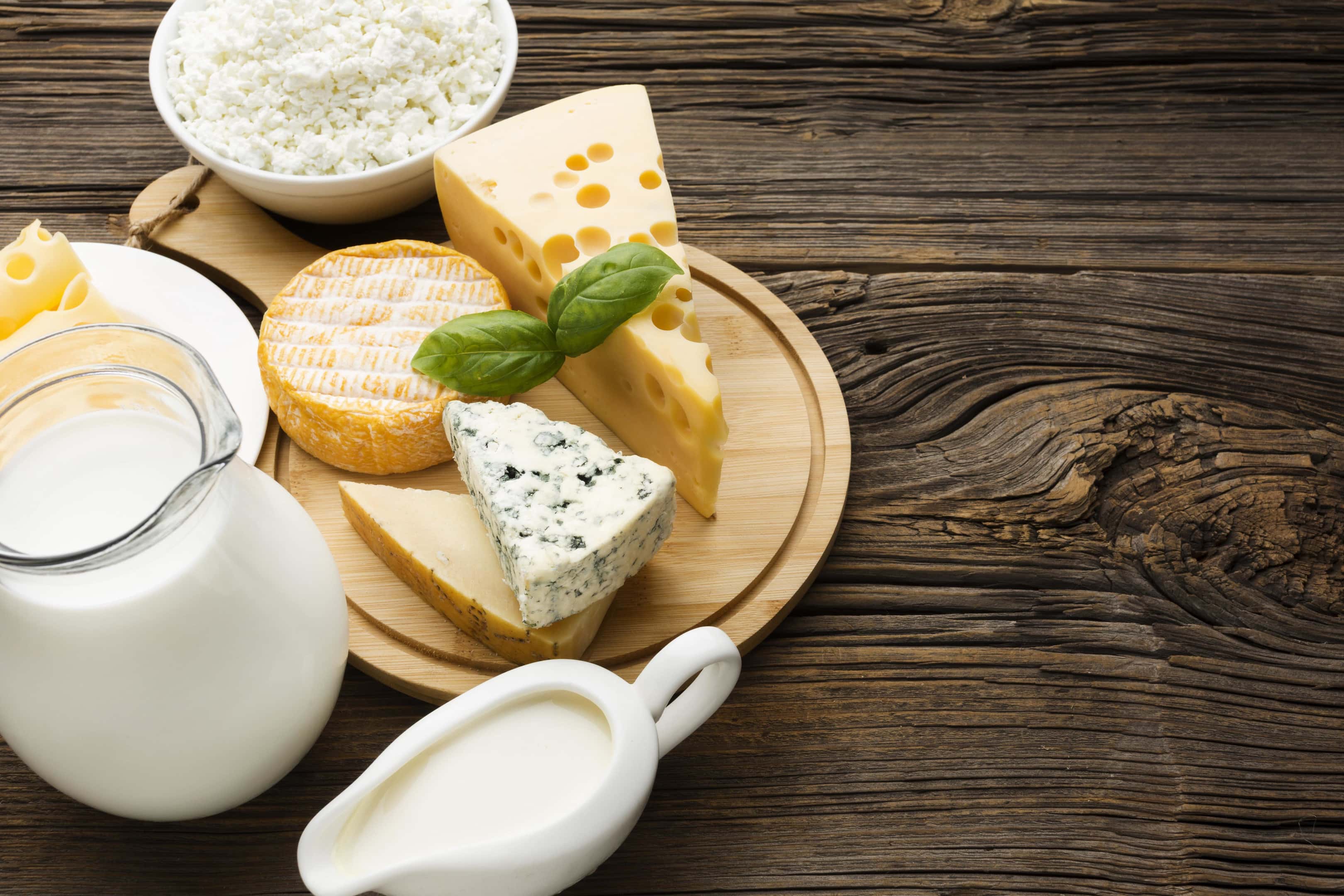 Cheese With Milk on Wooden Table
