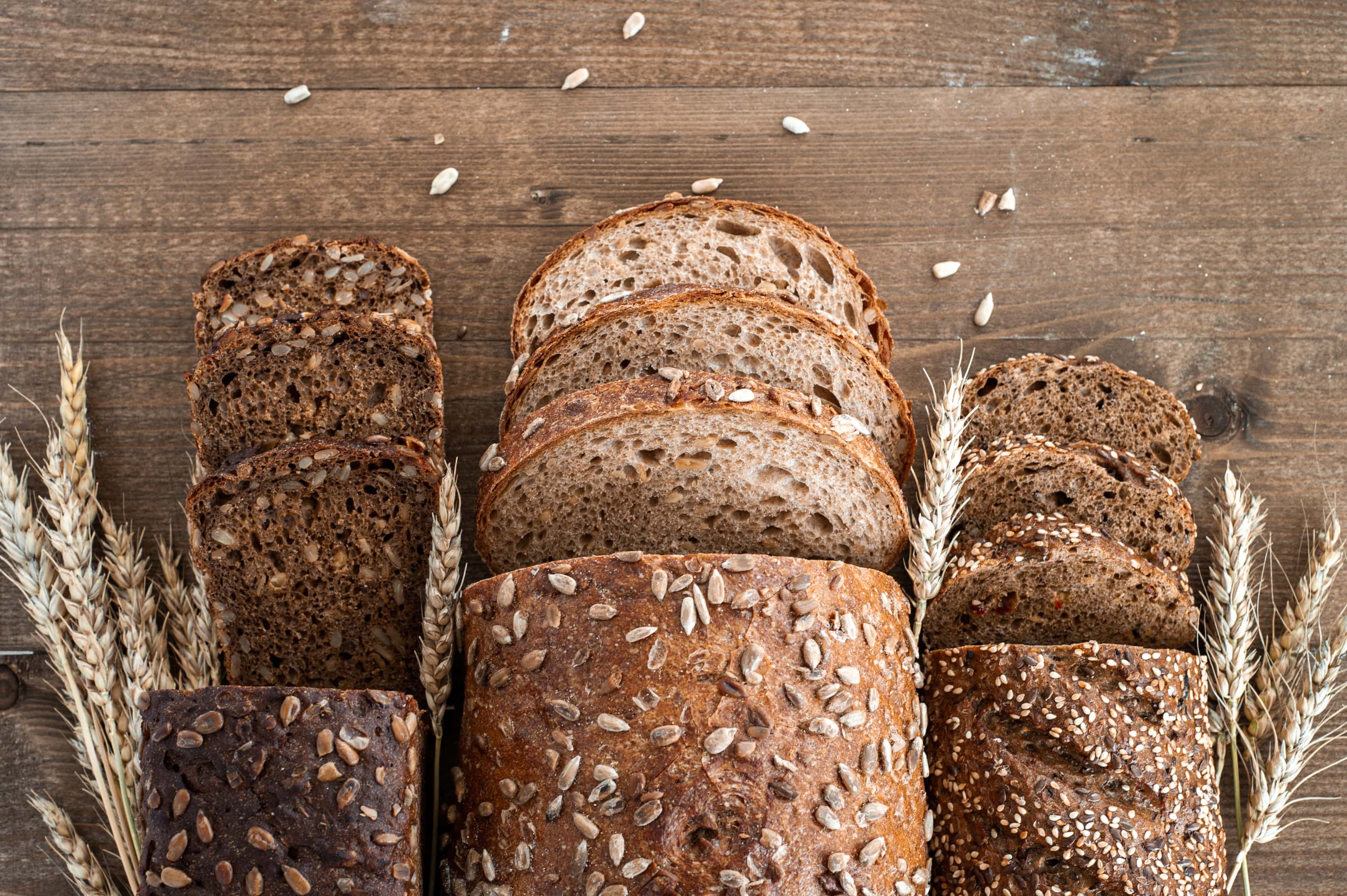 Different Loaves of Whole Grain Bread Are Cut Into Pieces