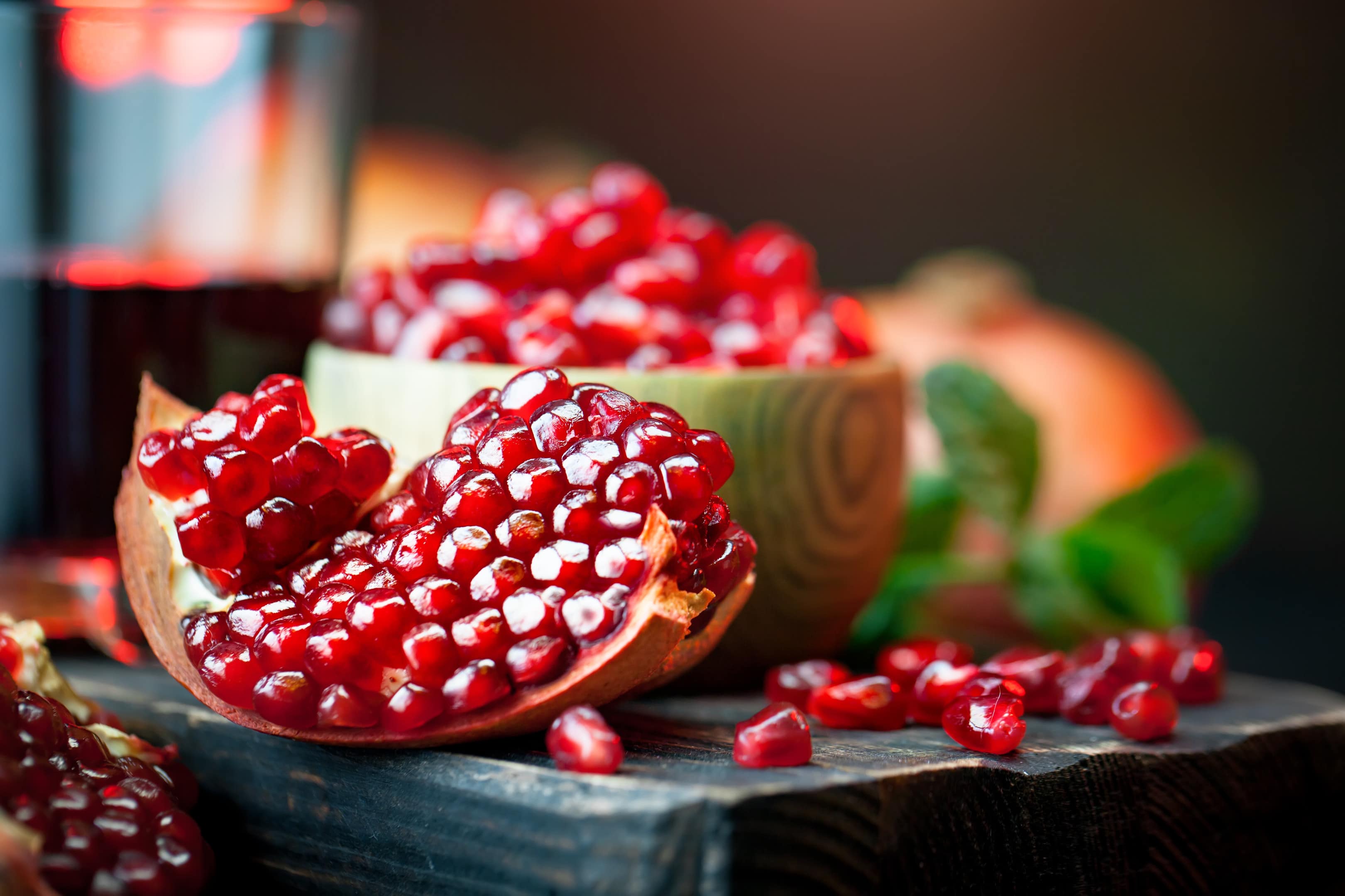 Ripe Pomegranate Fruit on Old Black Wooden Board