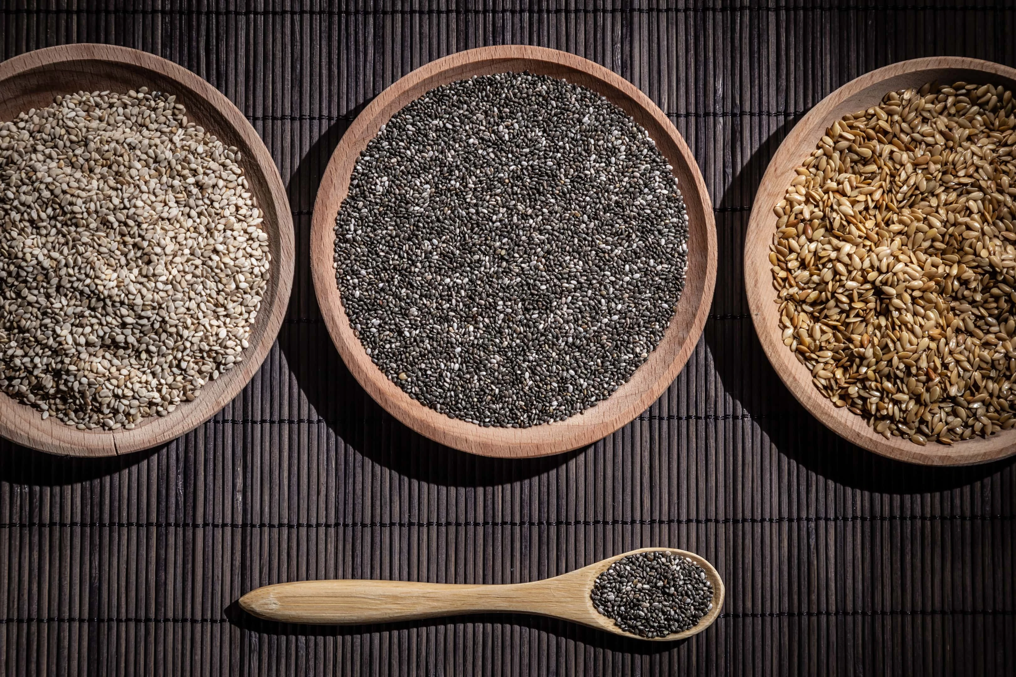 Sesame Chia and Flax Seeds in Wooden Dishes