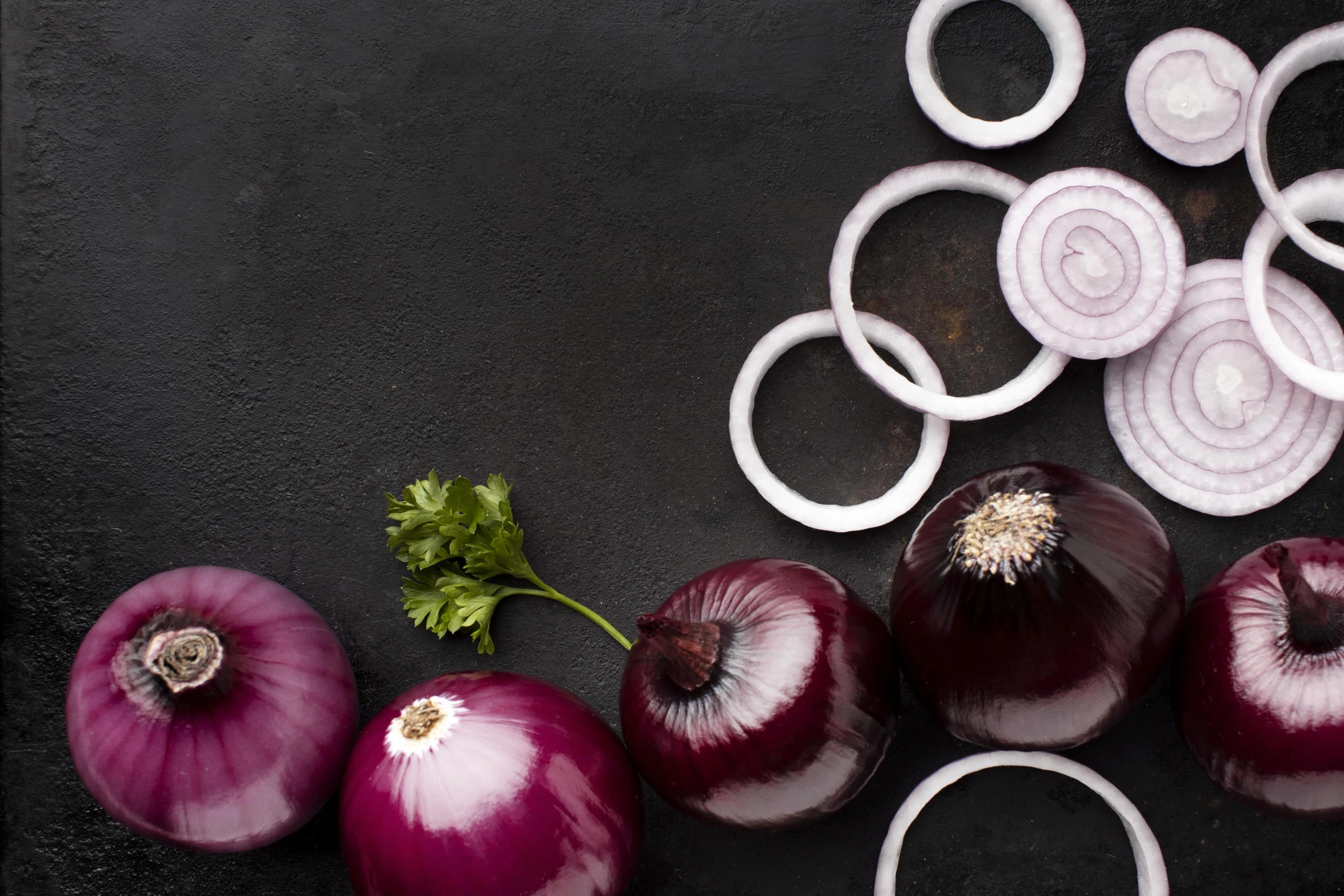 Arrangement of red onions on grey table