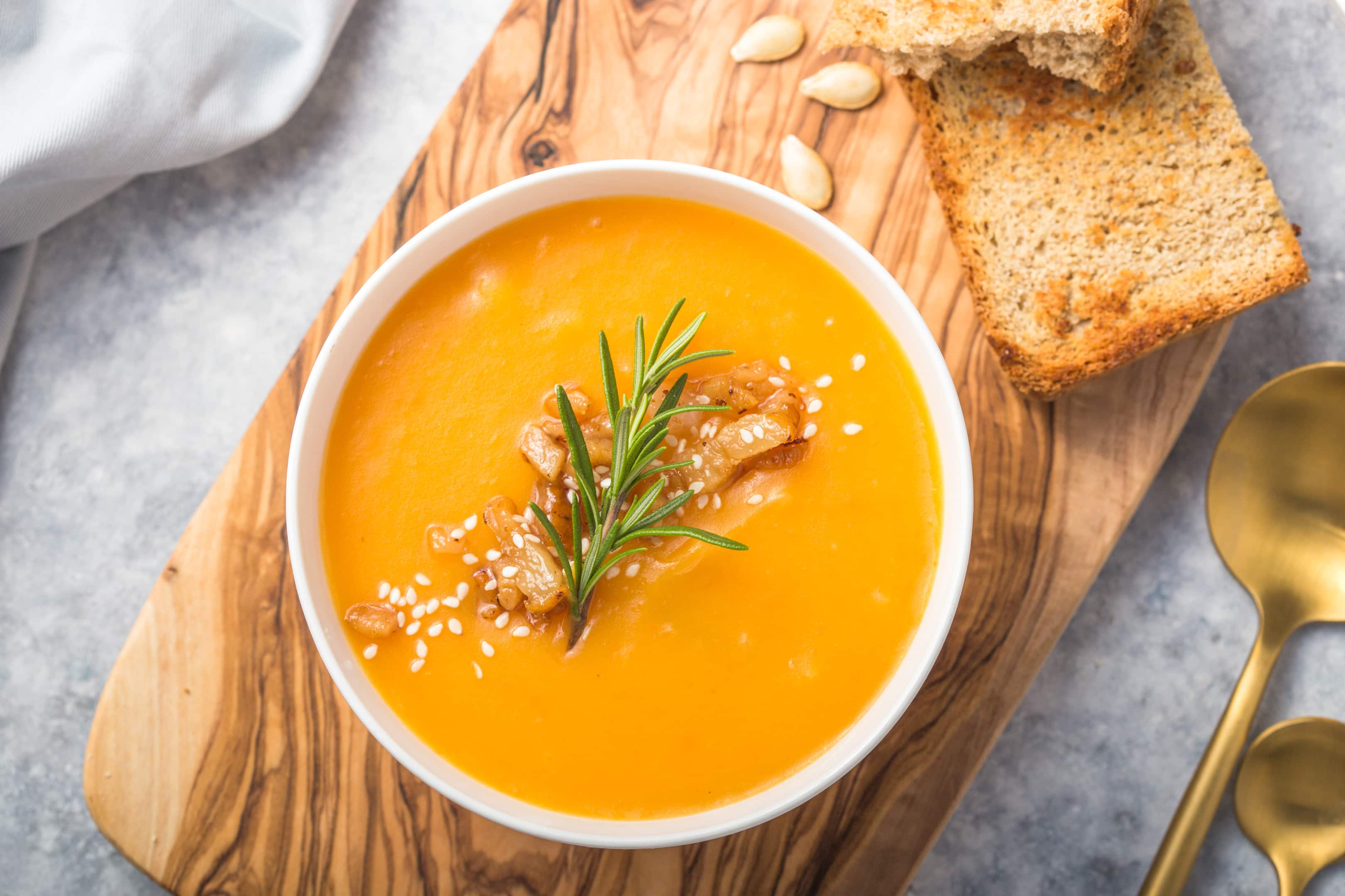 Butternut squash soup with bread and seeds