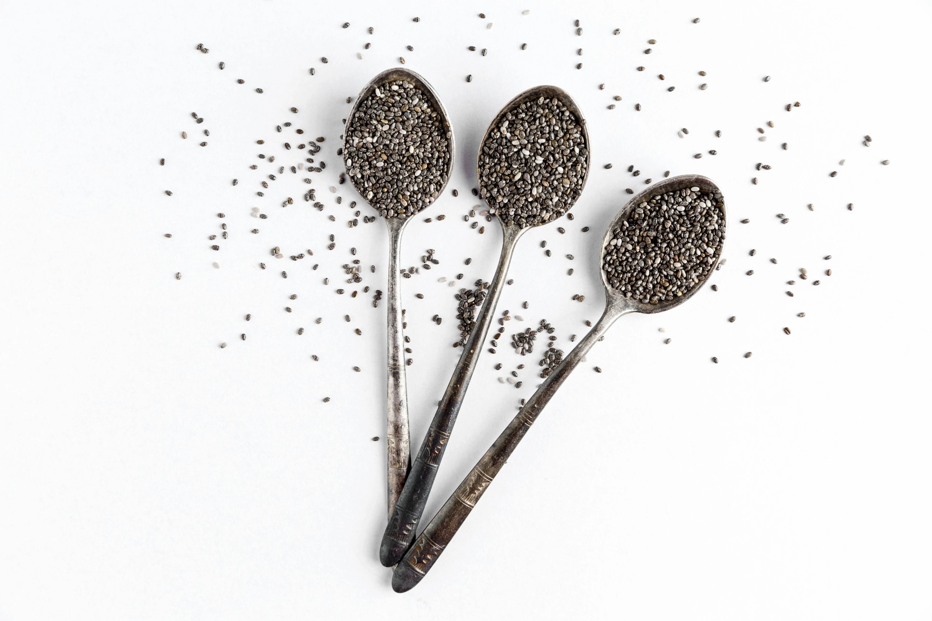 Chia seeds in metal spoons