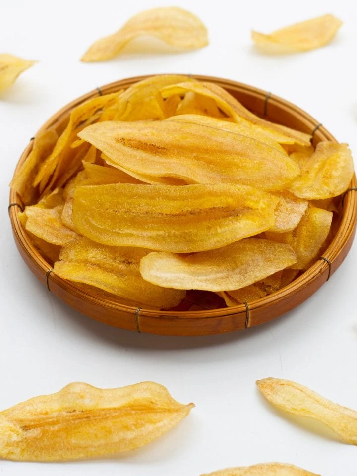Dehydrated banana chips on white background