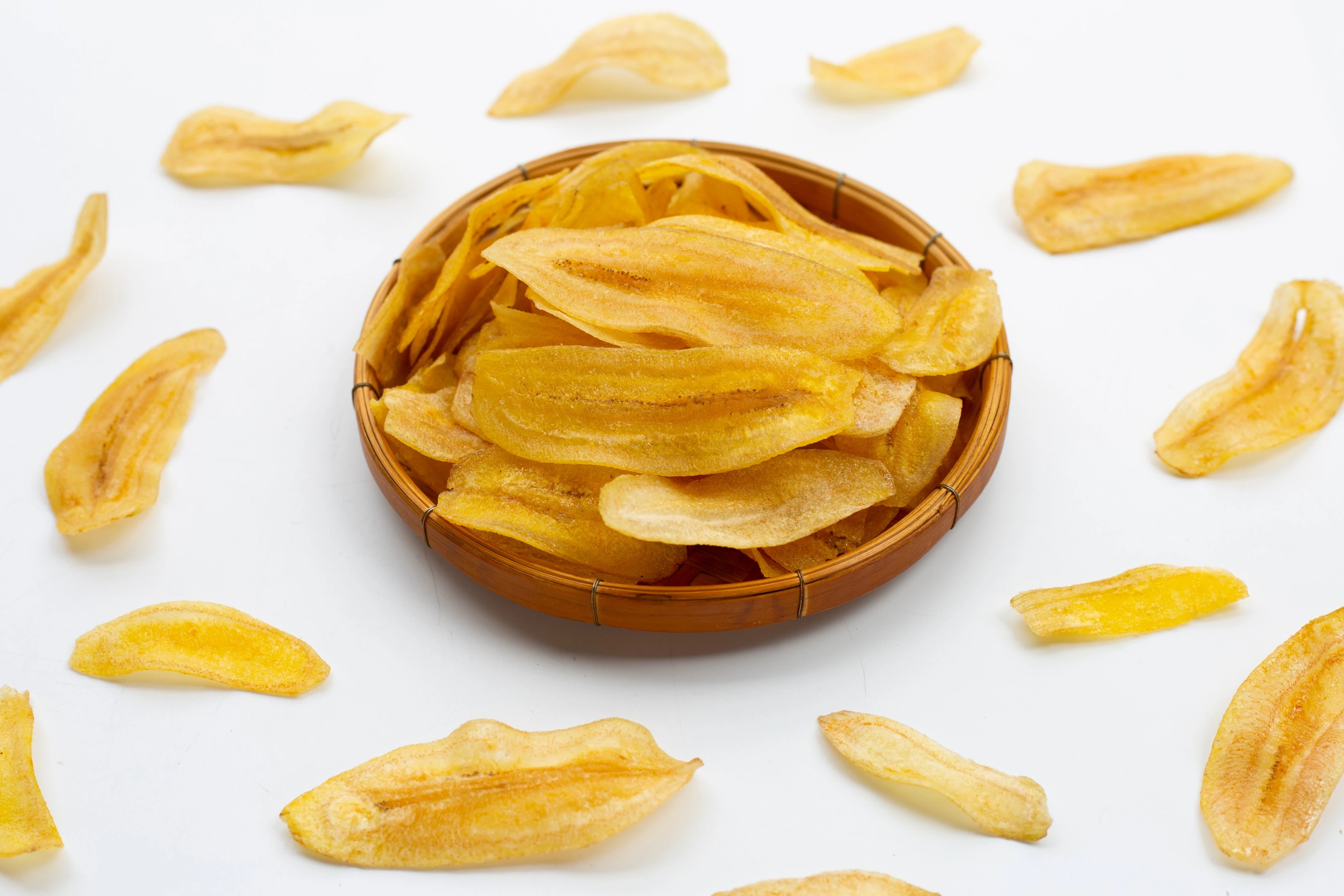 Dehydrated banana chips on white background