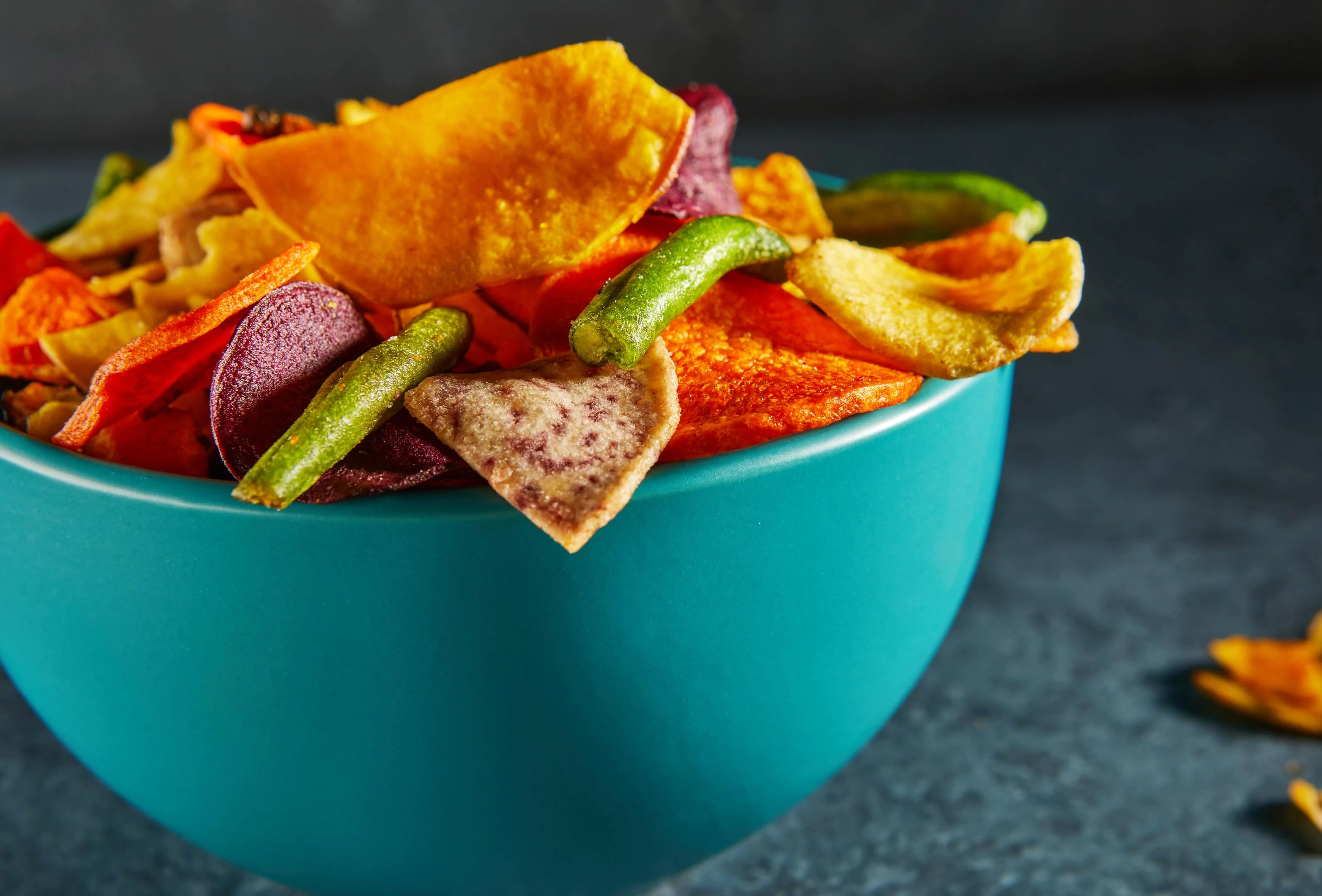 Dehydrated vegetable chips in blue bowl