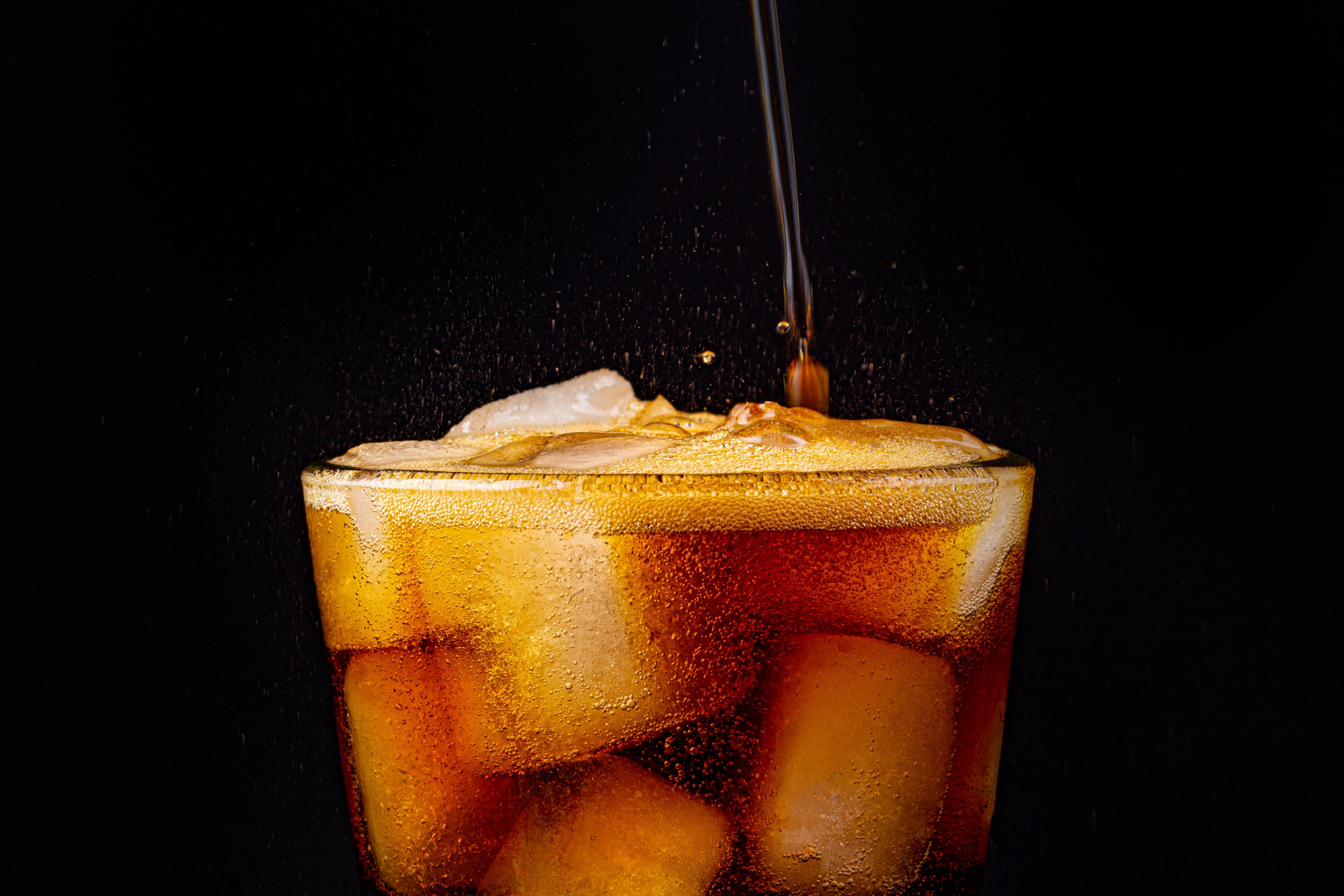 Fizz sparkling cola soda with ice cubes