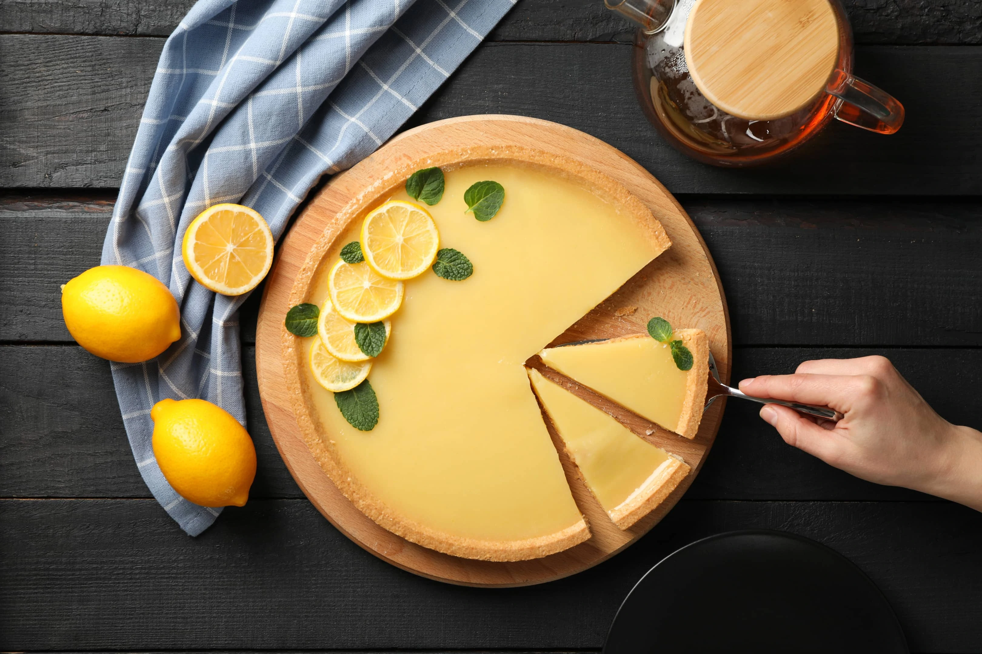 Lemon tart on dark wooden background