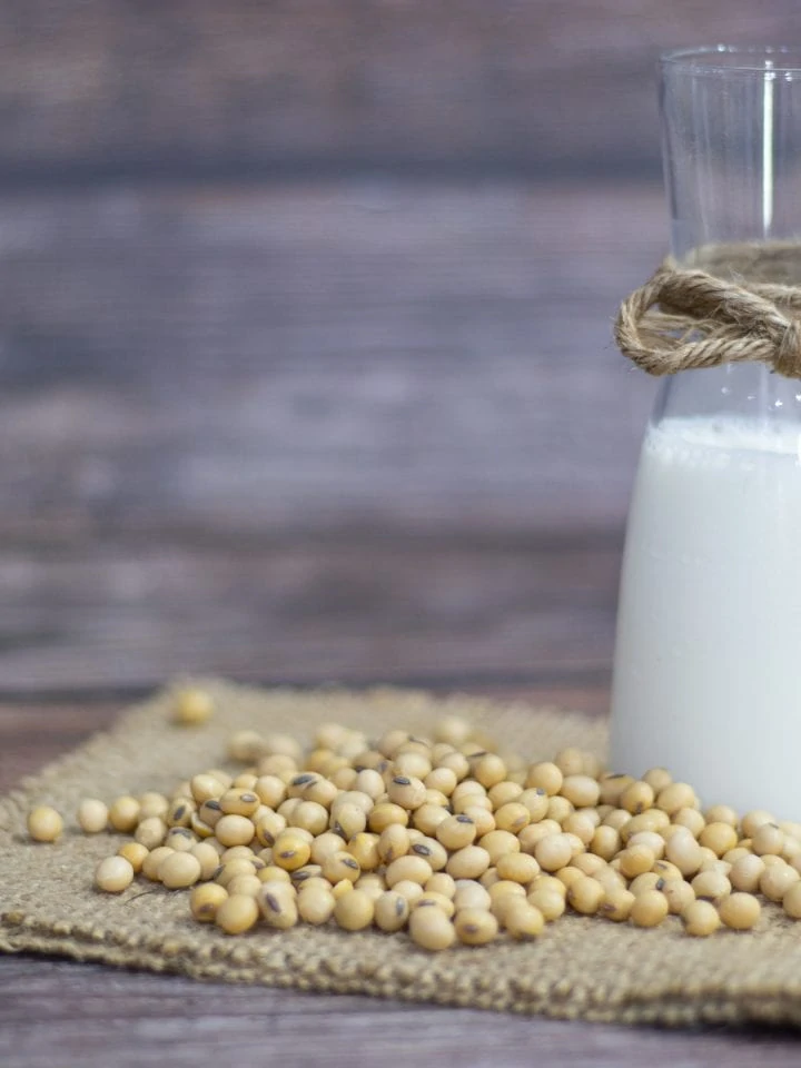 Soybeans and soy milk on wooden table