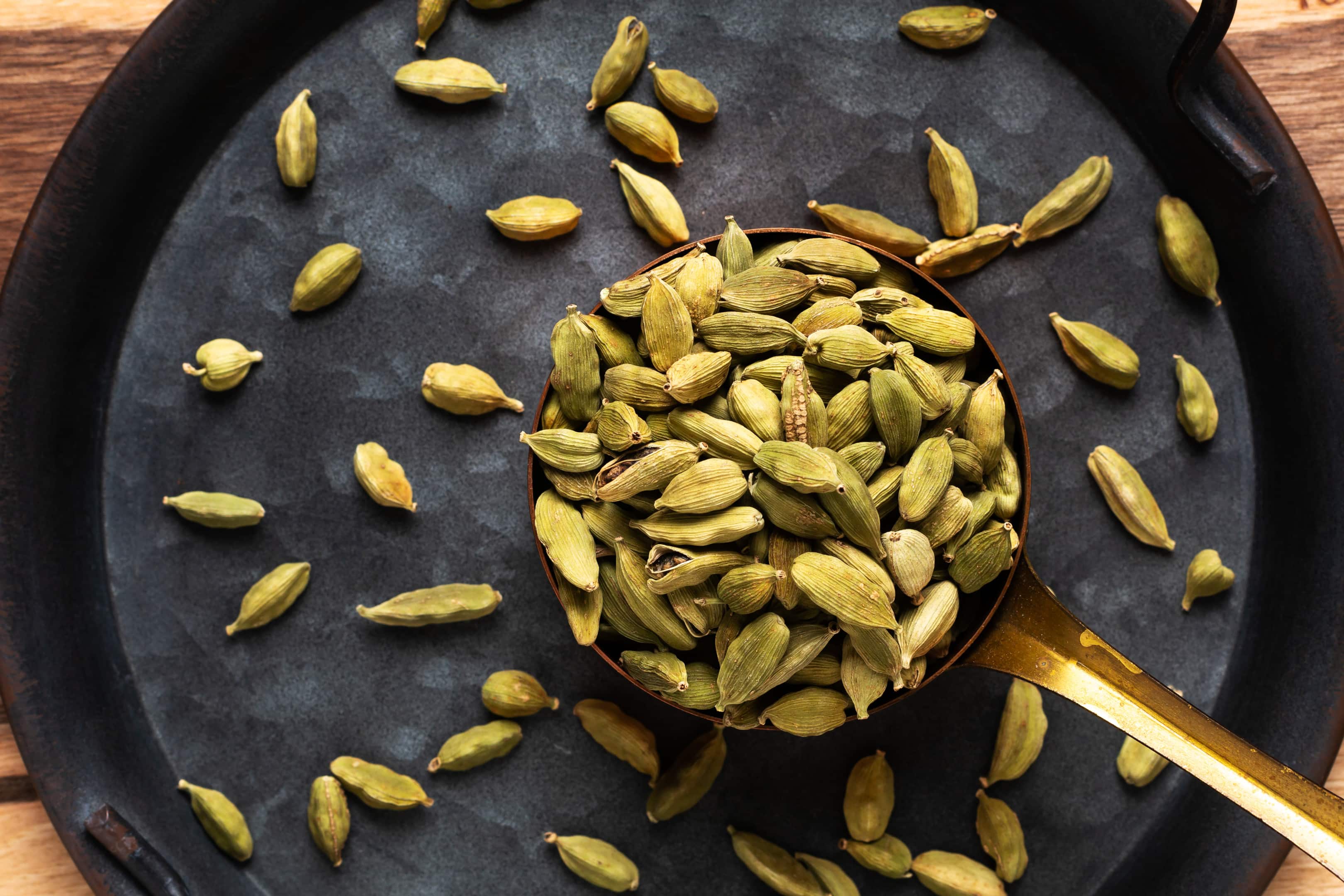Cardamom pods in a pan