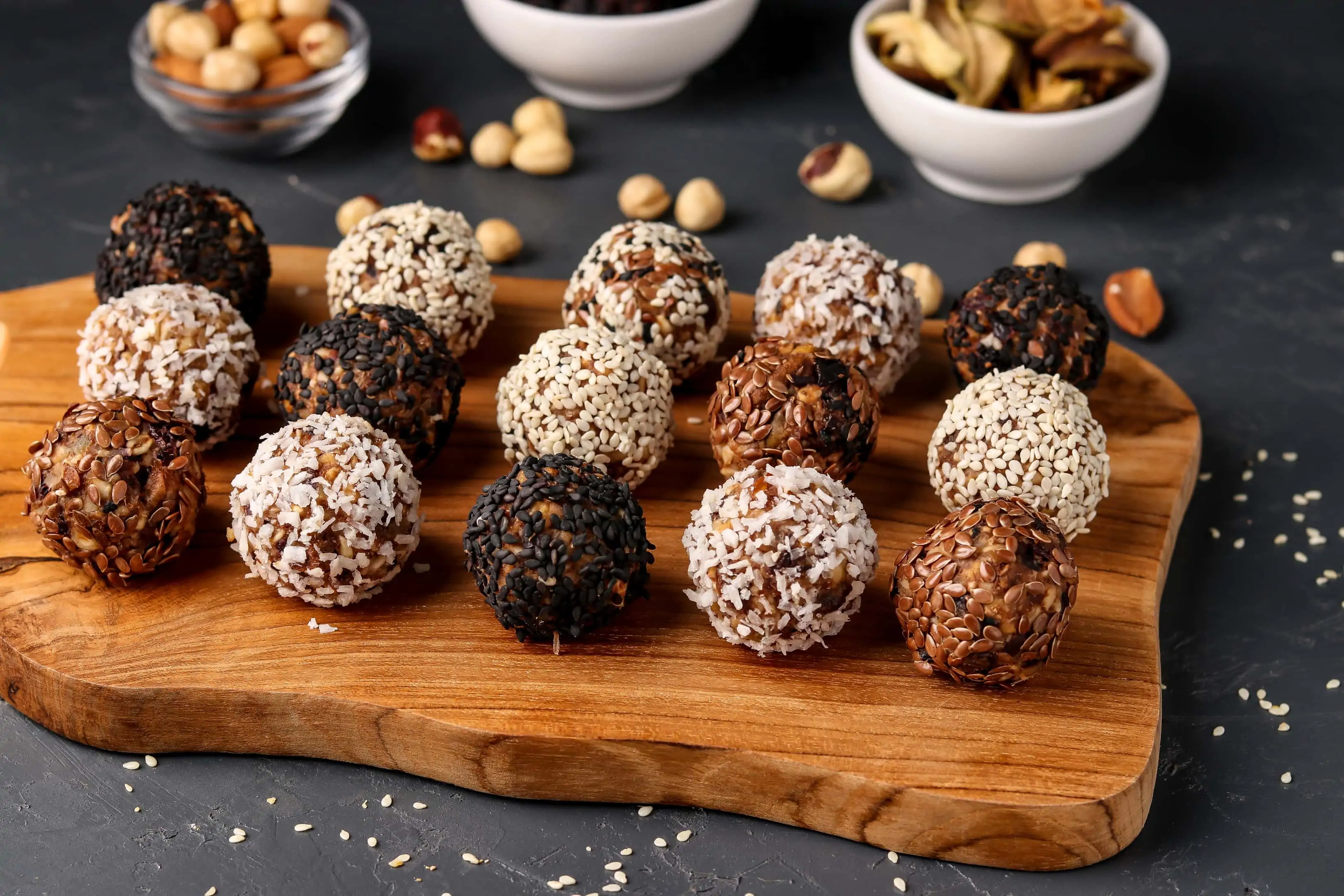 Energy balls with nuts oatmeal and dried fruit on wooden board
