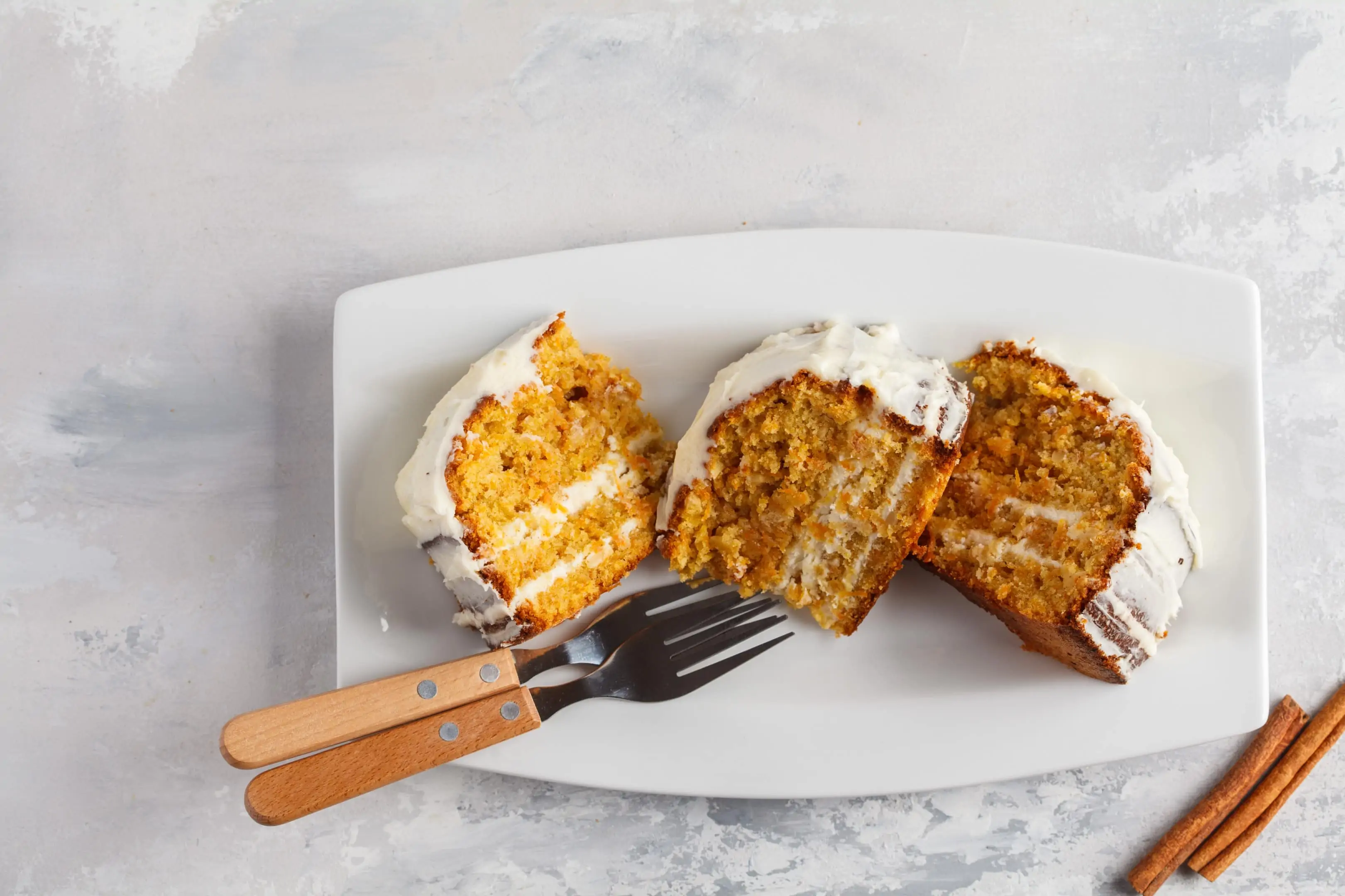 Homemade carrot cake with white cream in white plate