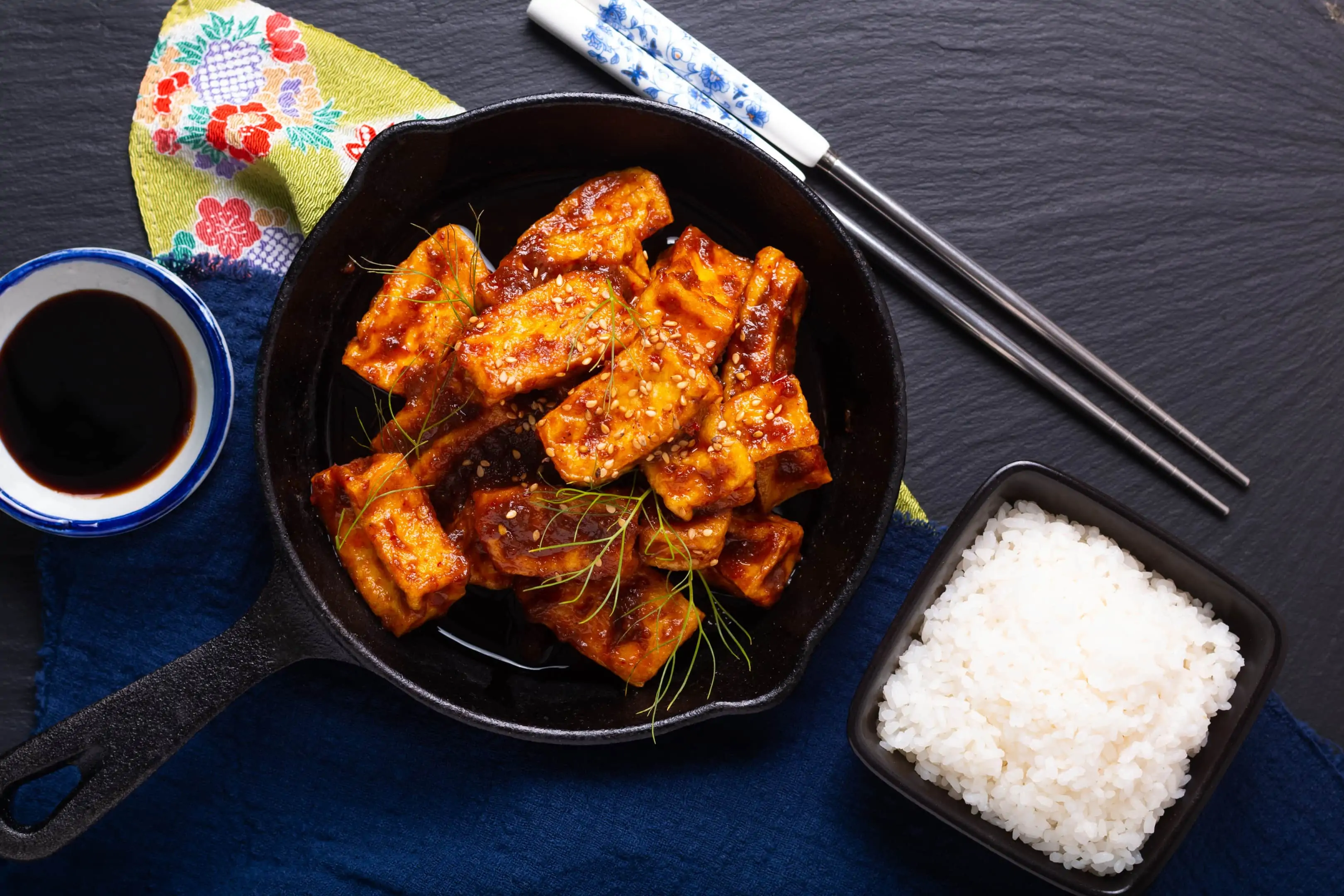 Homemade stir fried tofu with spicy chili sauce served with rice