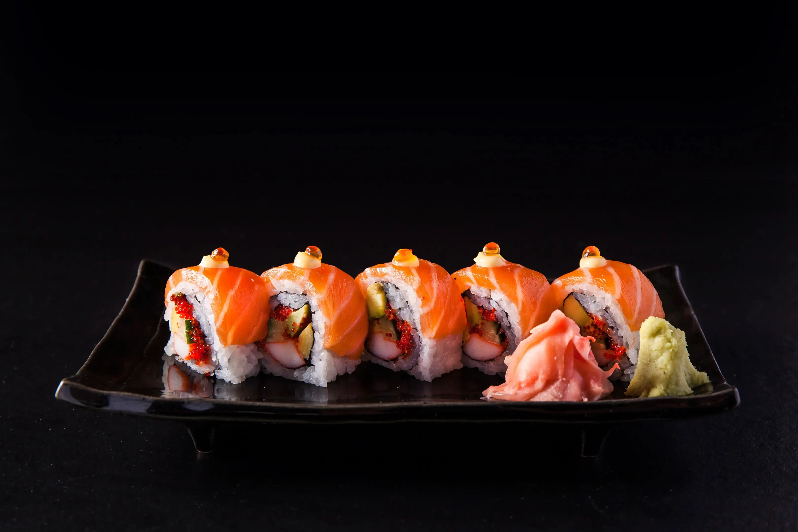 Salmon sushi roll with salmon eggs