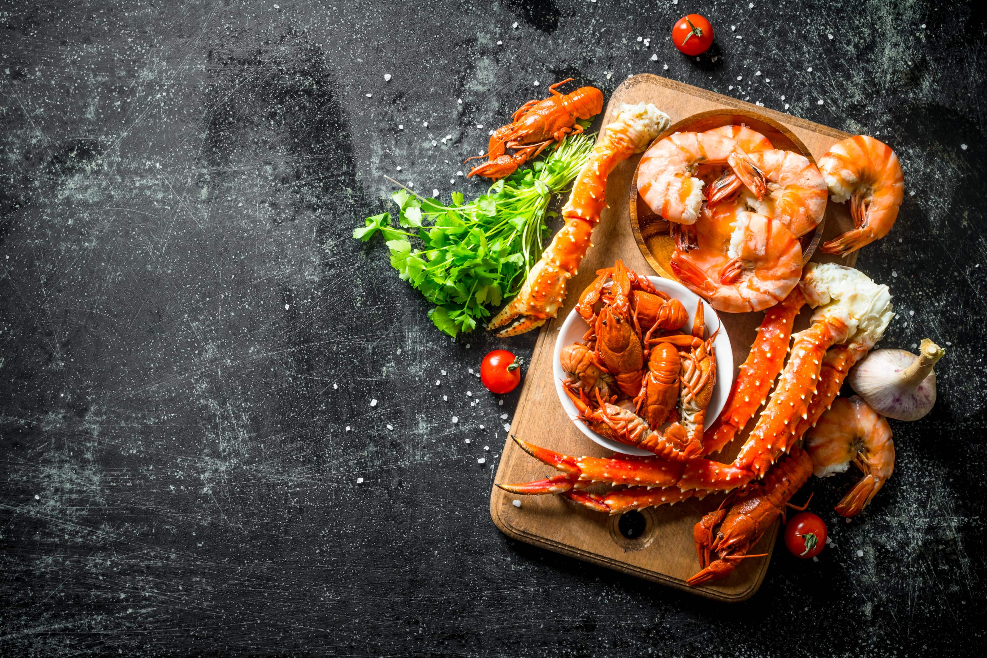 Seafood fragrant shrimp crayfish and crab on wooden board with herbs