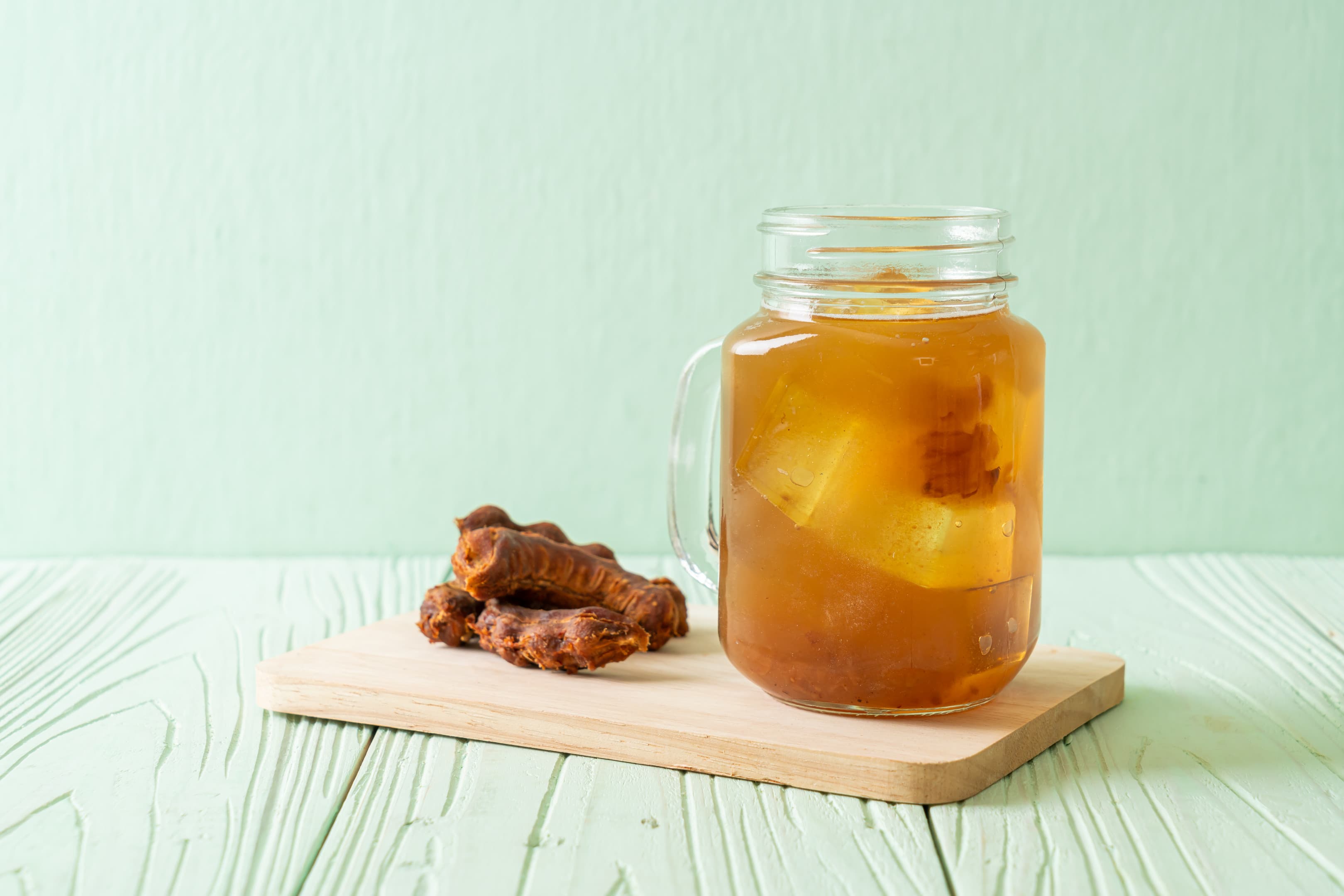 Tamarind and turmeric drink on wooden board