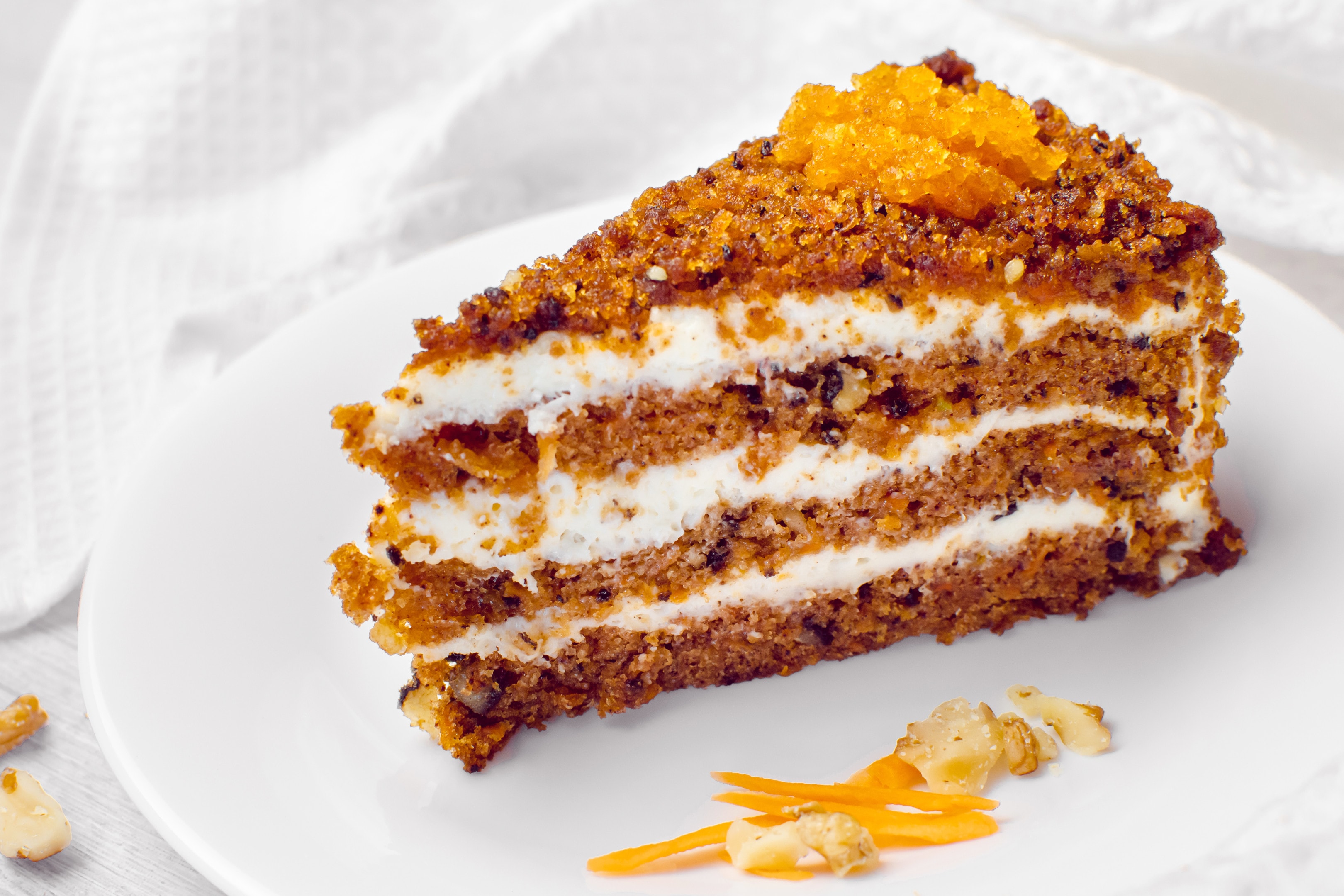 A piece of carrot cake with walnuts