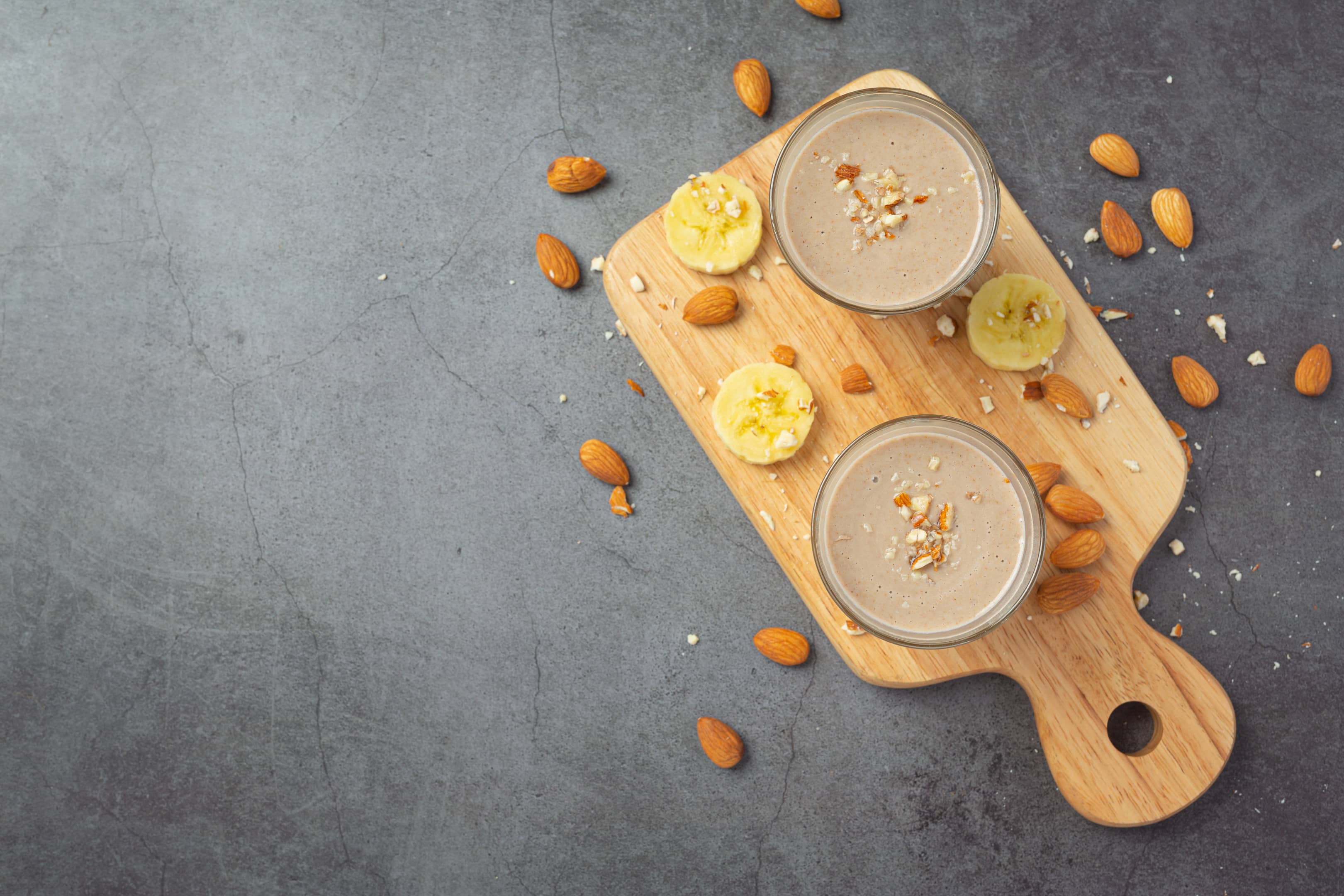 Banana & almond smoothie on dark background