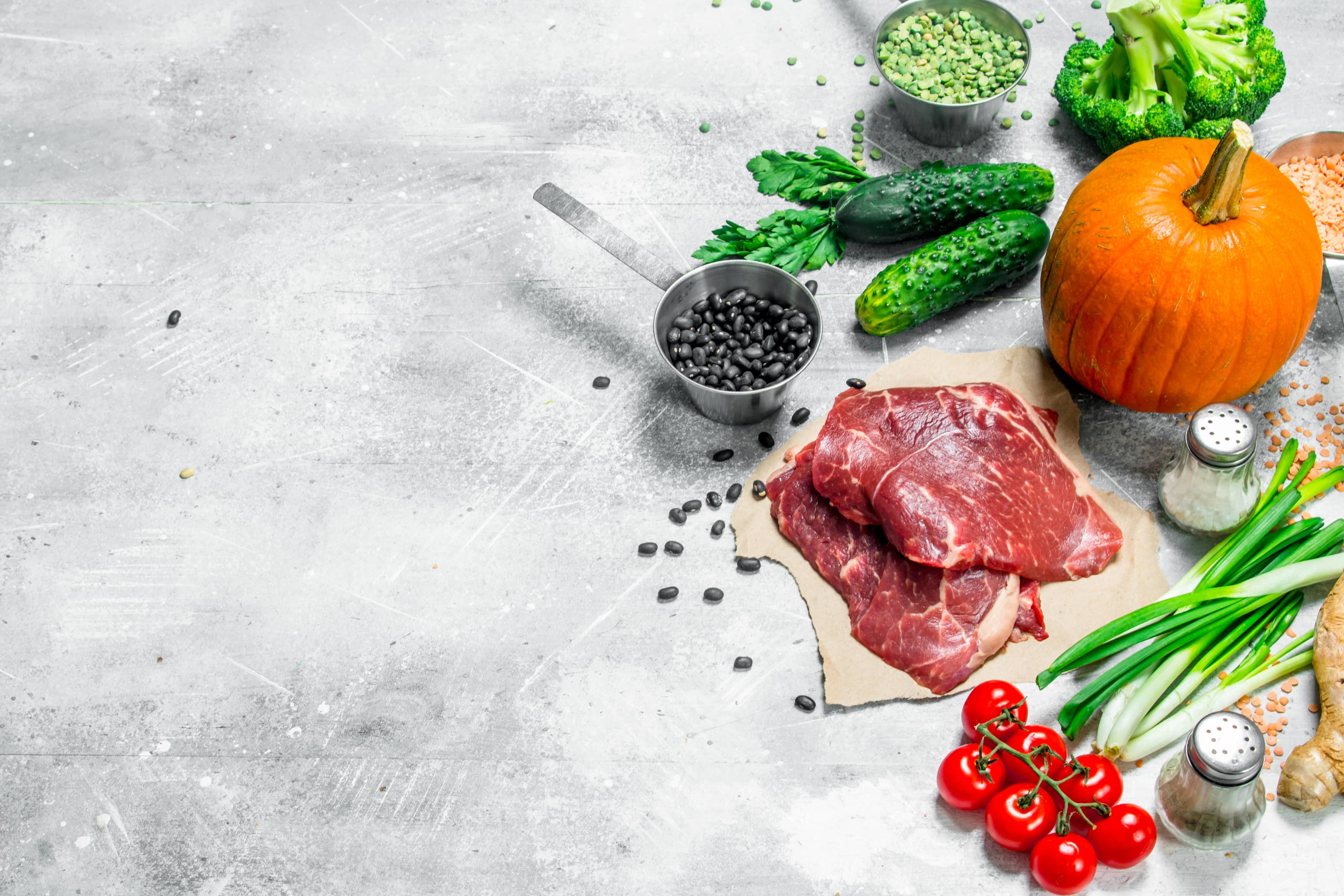 Healthy foods — raw lean beef, seeds, legumes and leafy vegetables