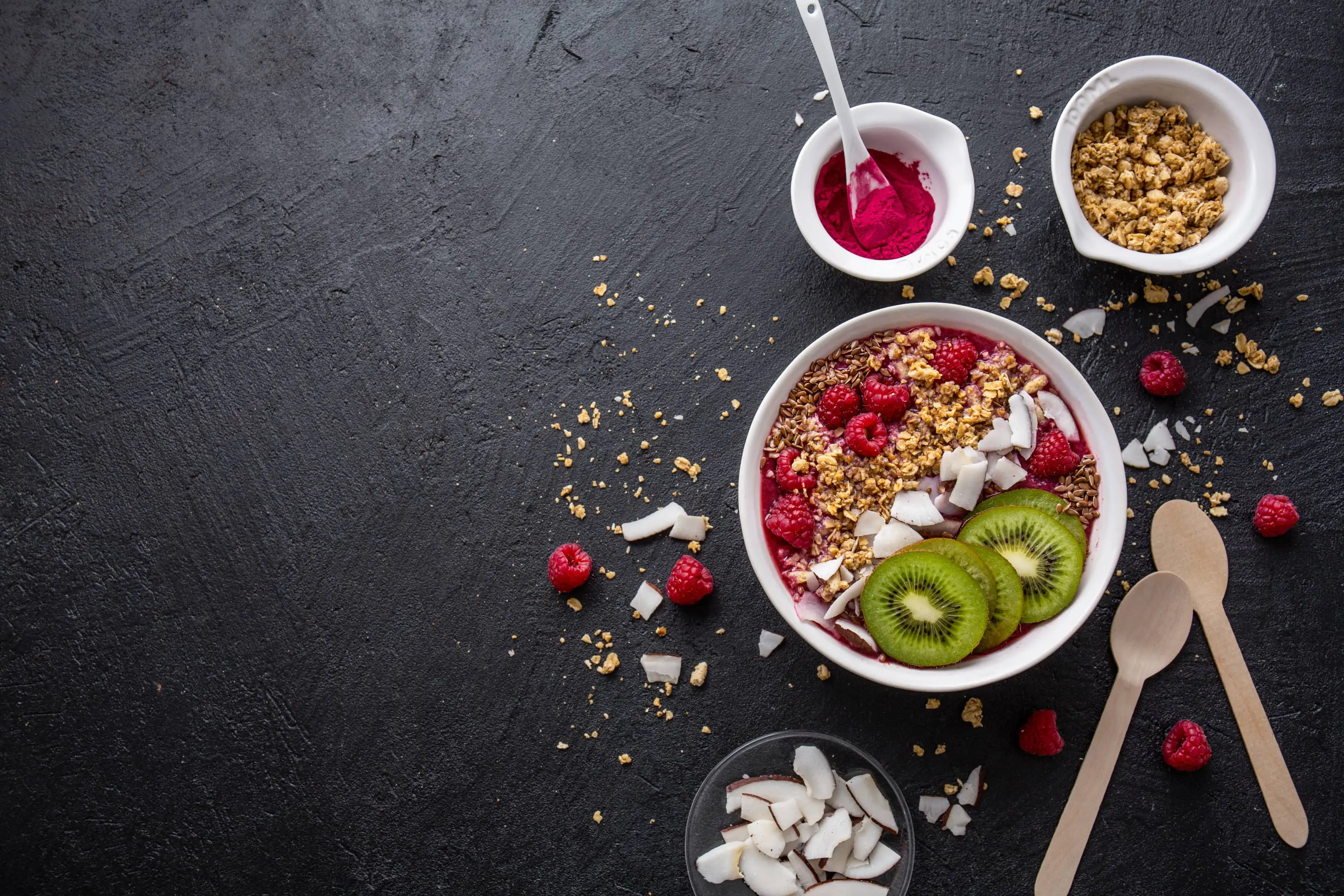 Homemade smoothie bowl made with berries, coconut, kiwi and oats